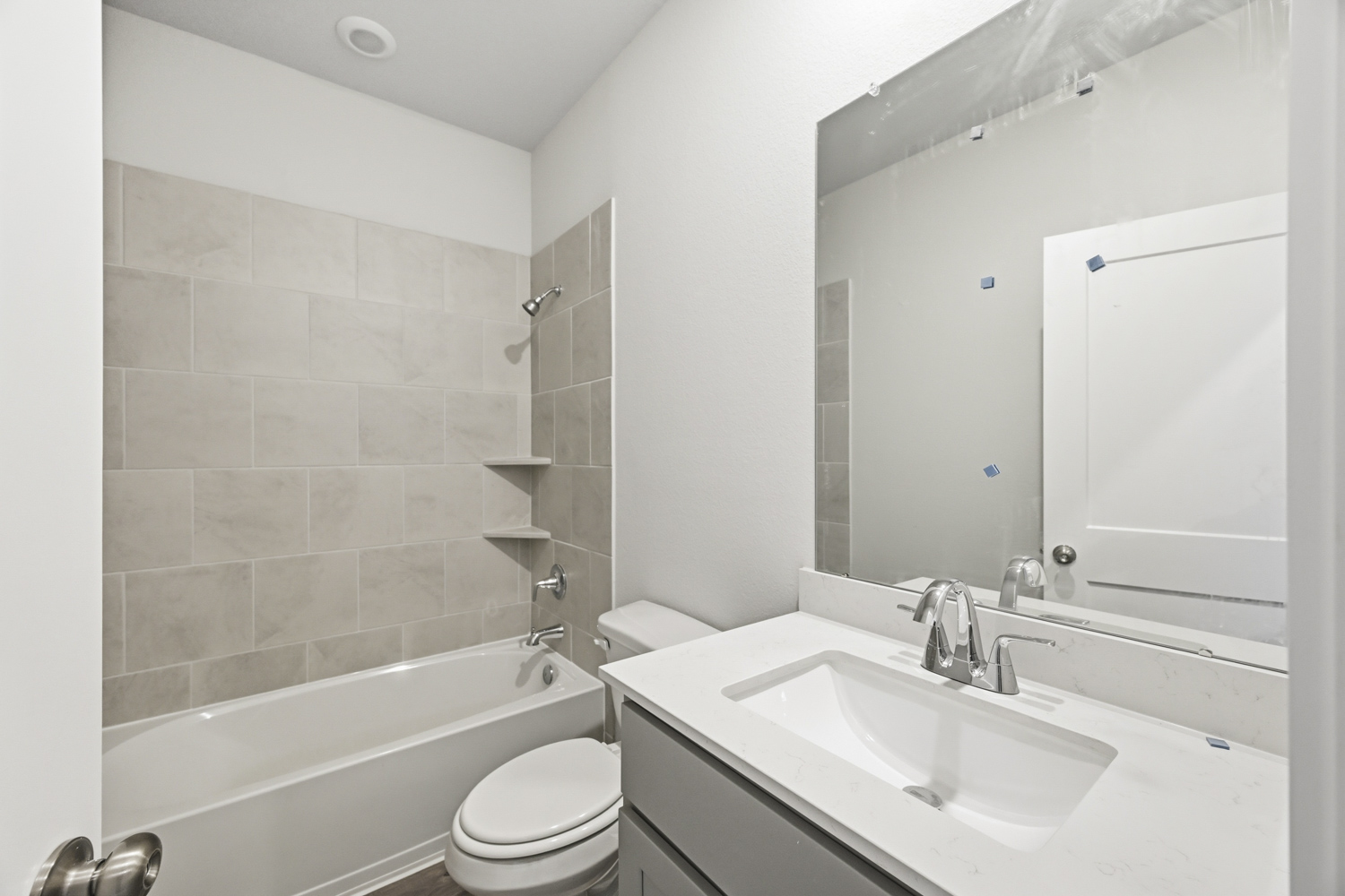 A bathroom with a tub sink and toilet.