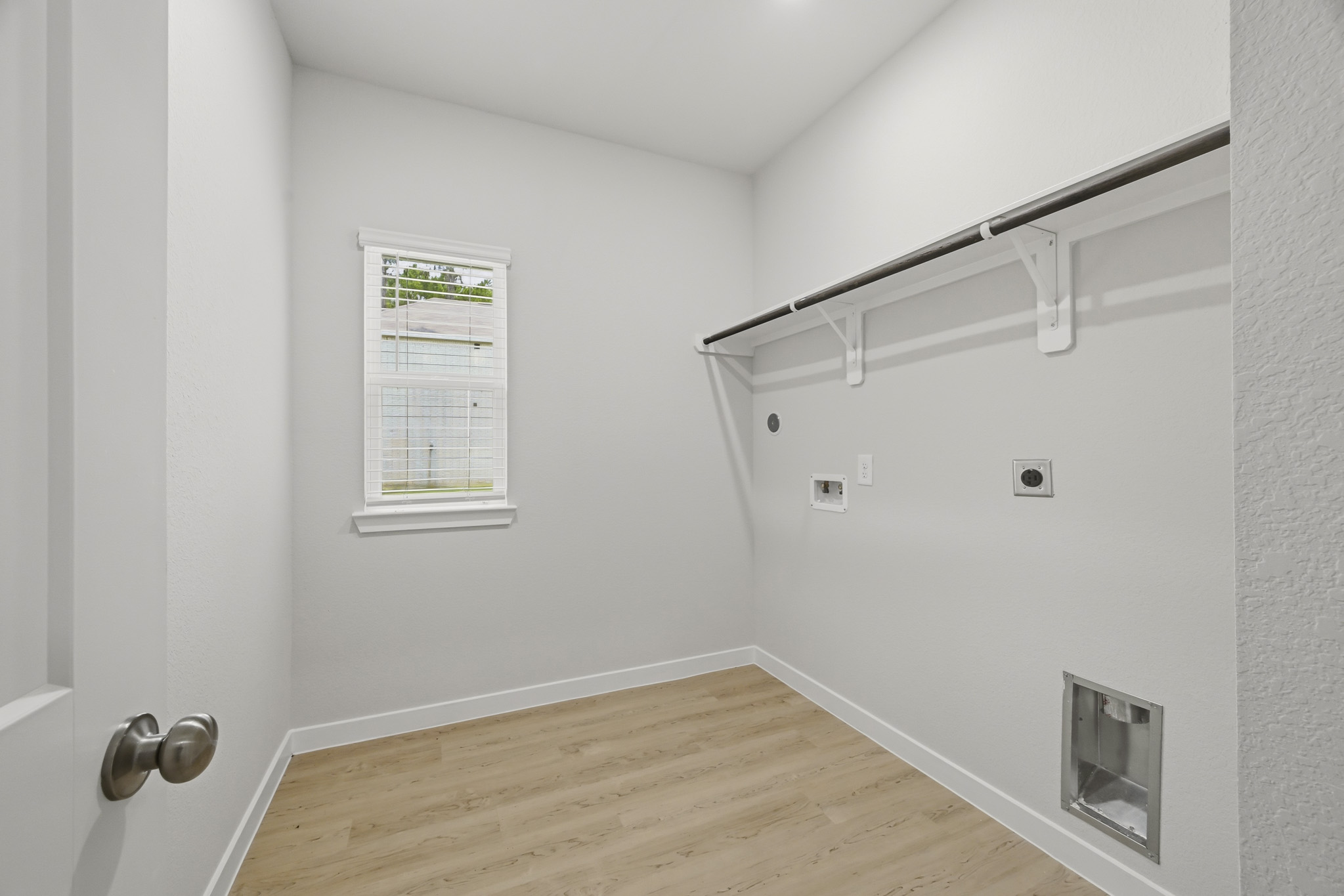 A room with a wood floor and a metal railing.