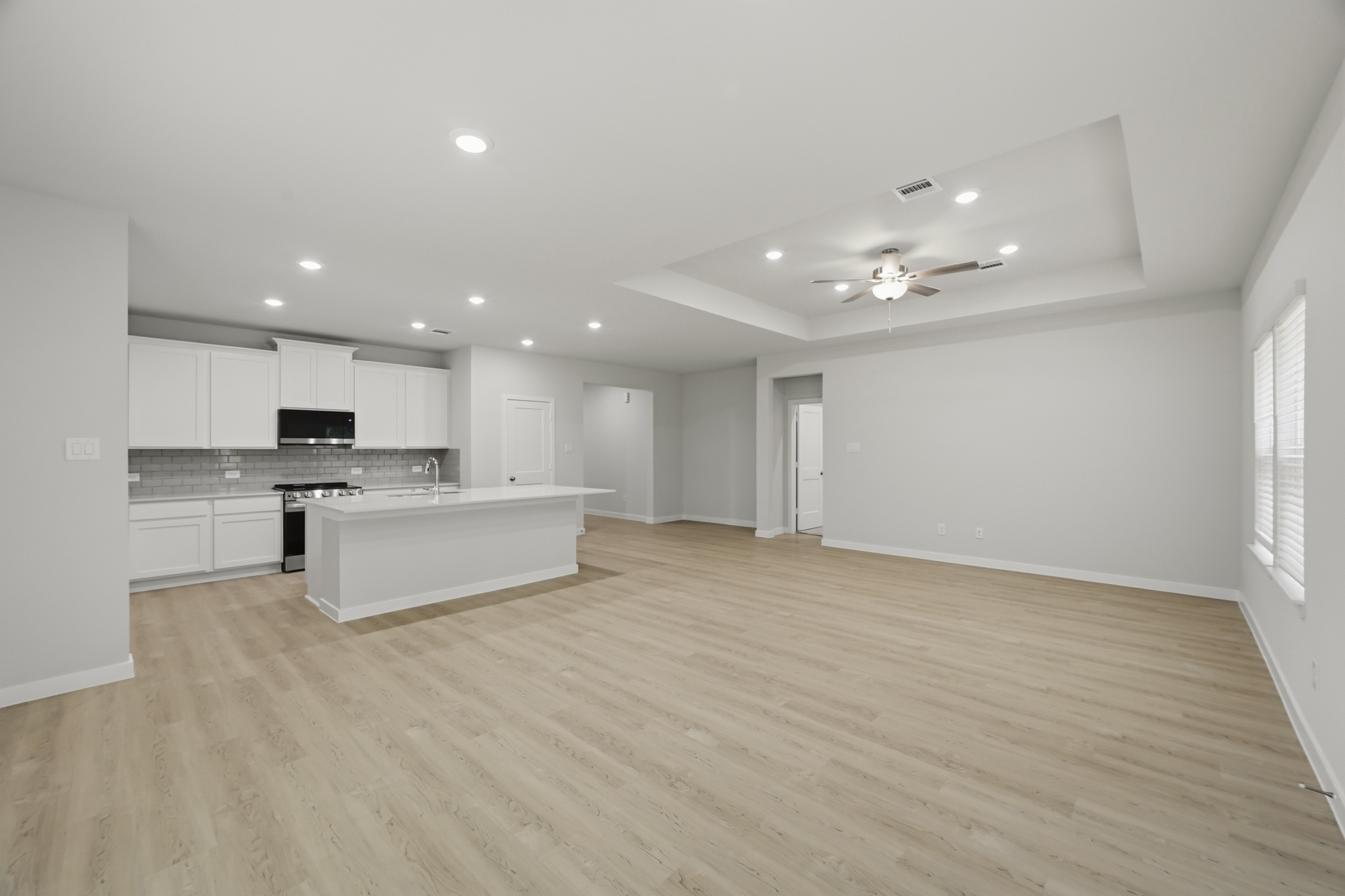 A large kitchen with white cabinets.