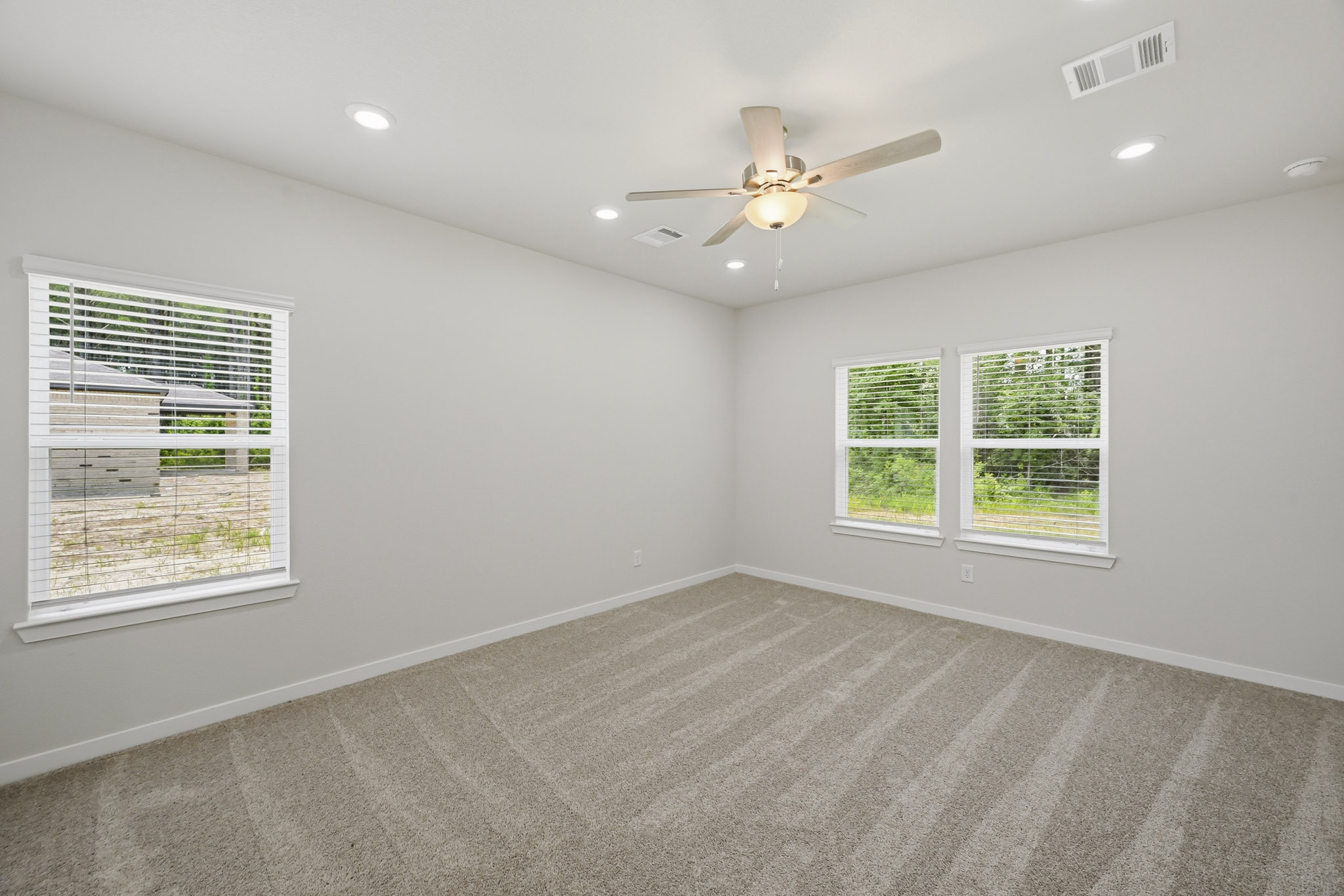 A room with a ceiling fan and a window.