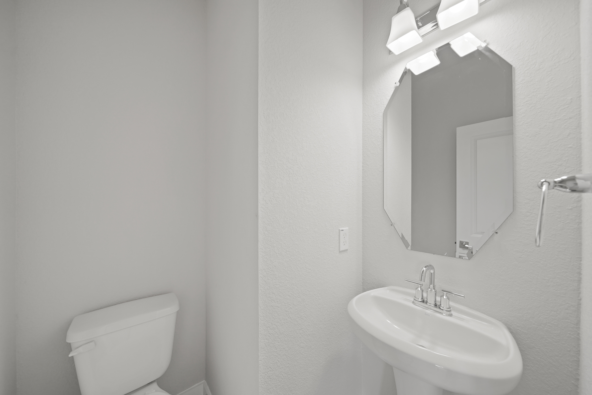 A bathroom with a mirror and sink.