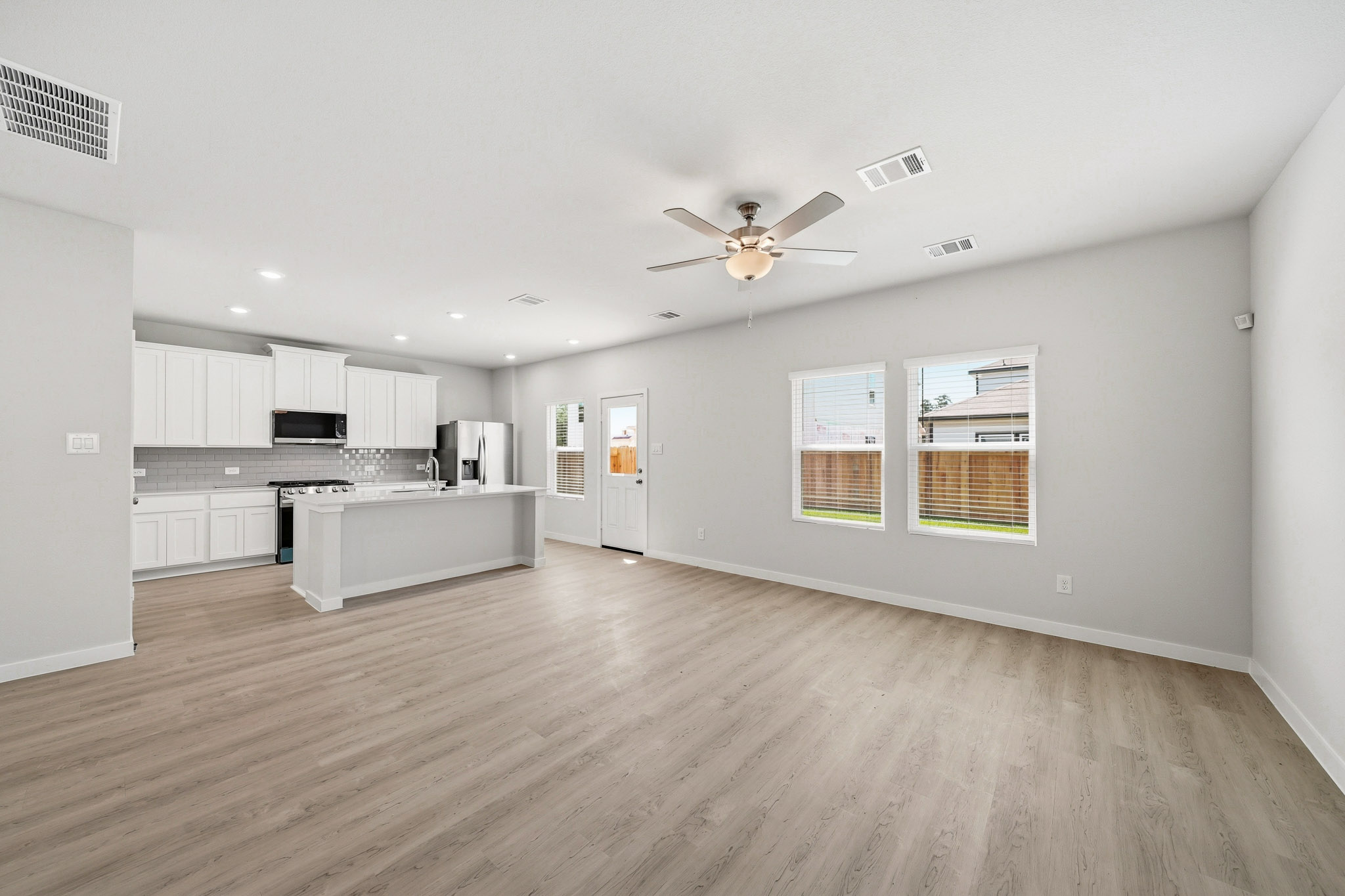 A large kitchen with white cabinets.