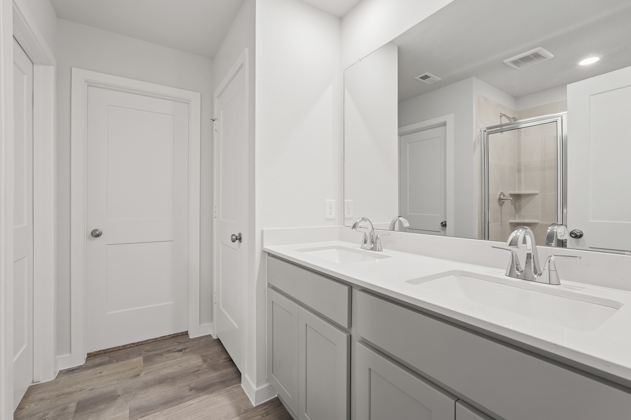 A bathroom with a large mirror.