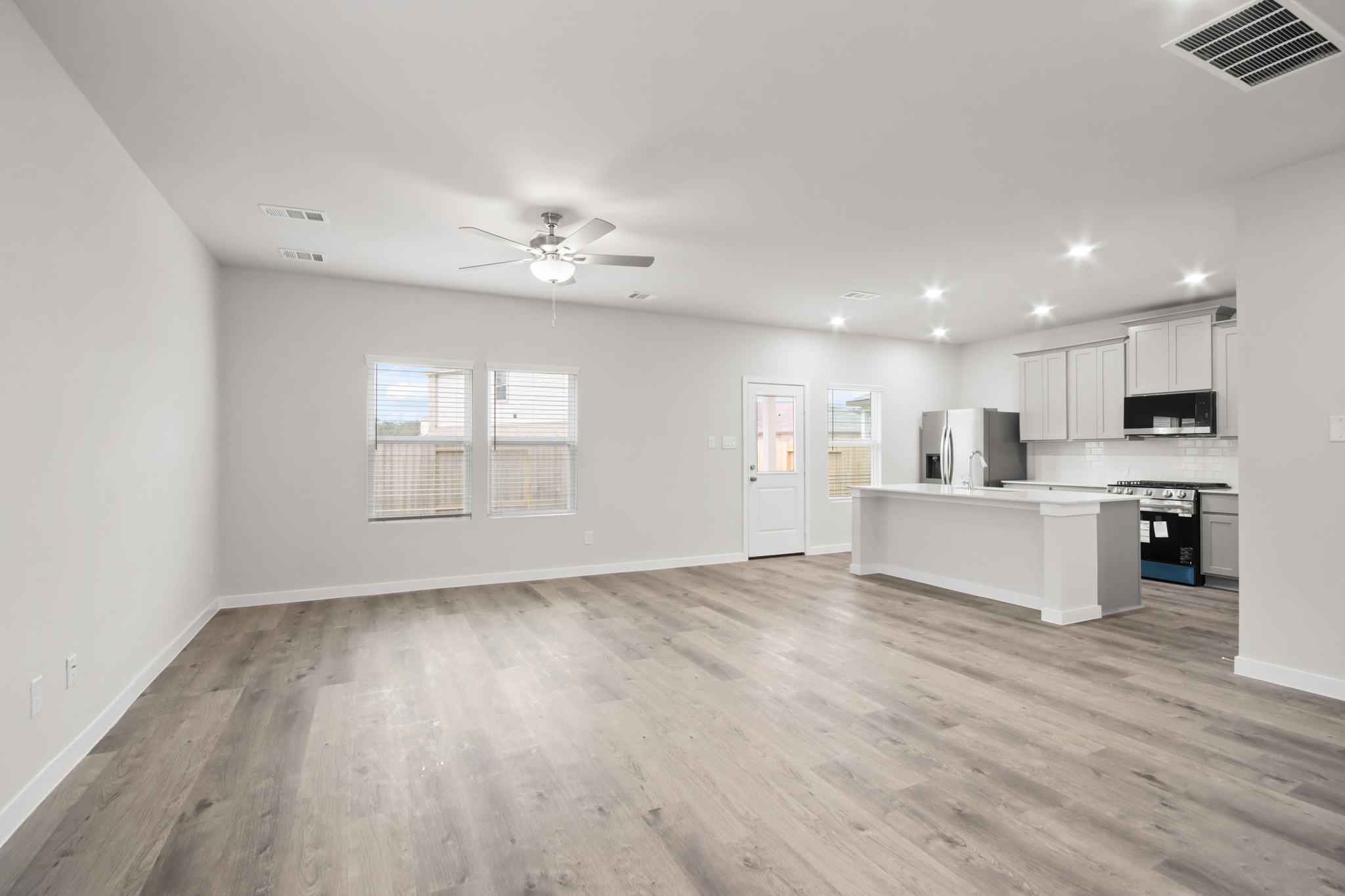 A large kitchen with white cabinets.
