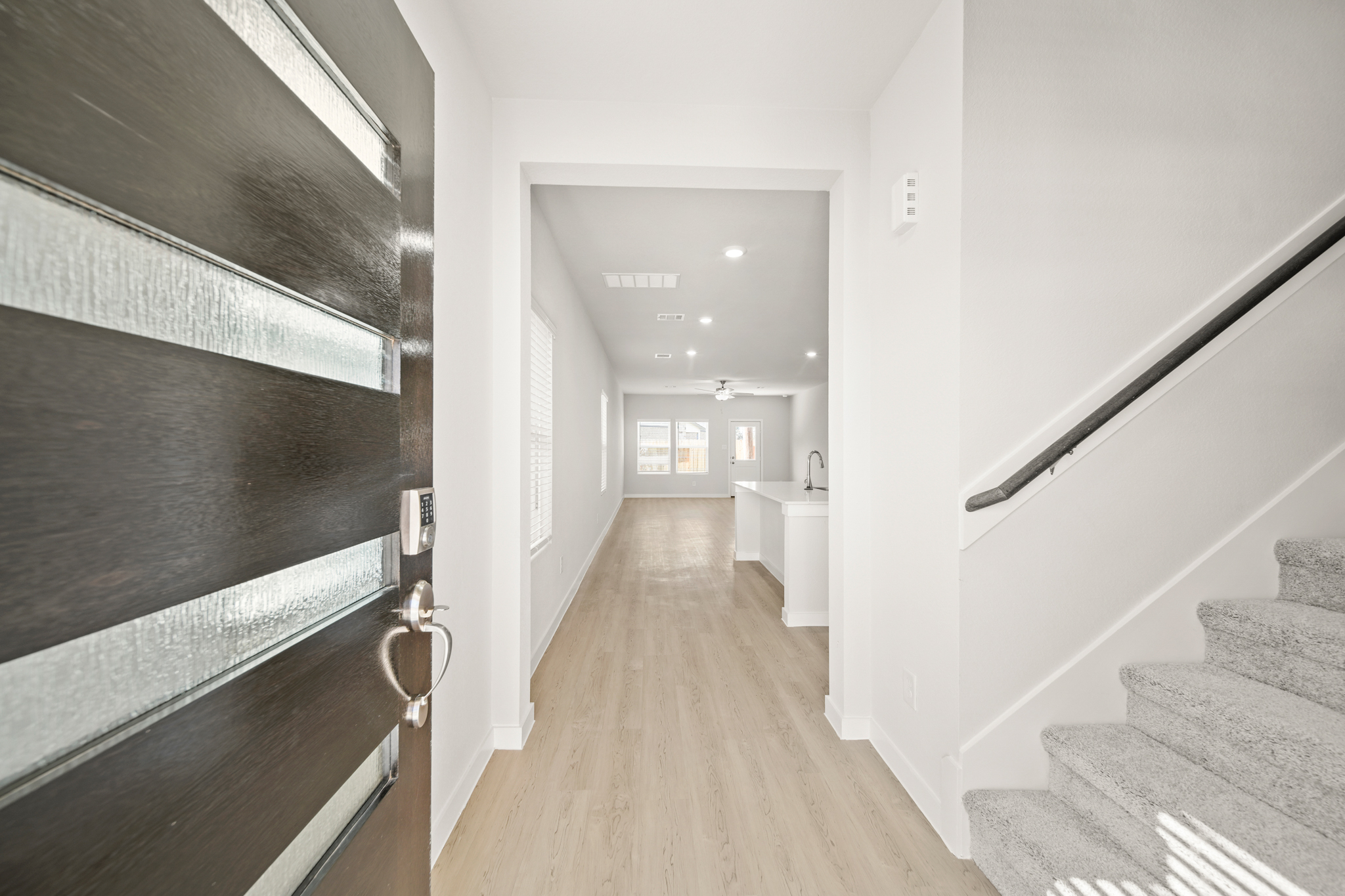 A hallway with a wood floor.