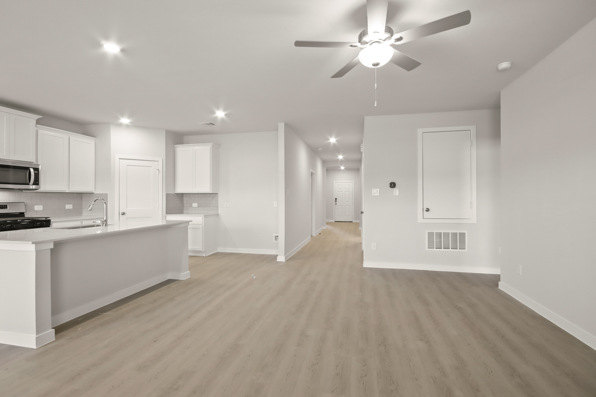 A kitchen with white cabinets.