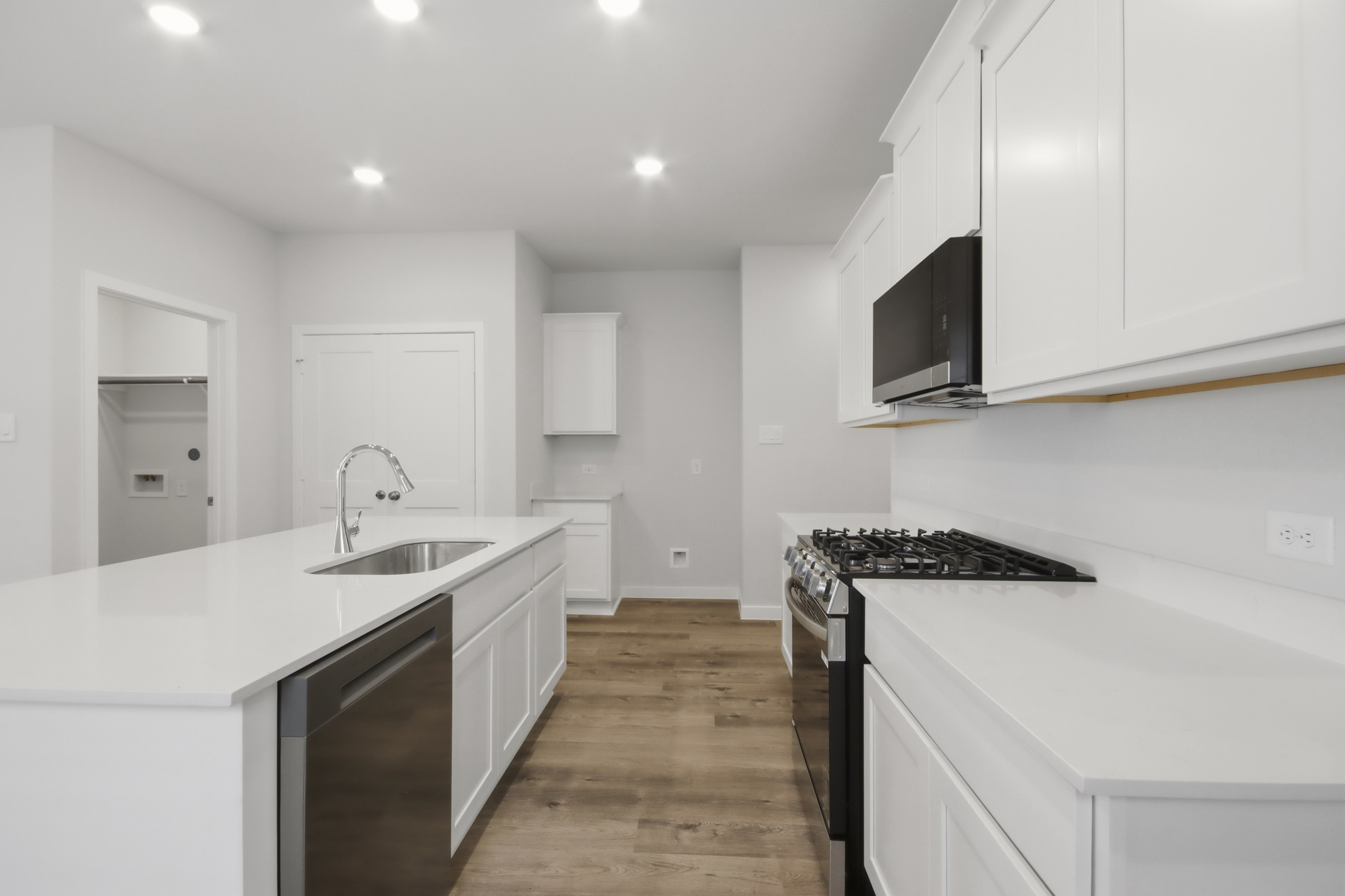 A kitchen with white cabinets.