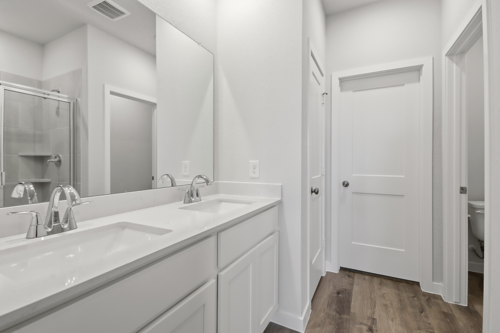A bathroom with a large mirror.