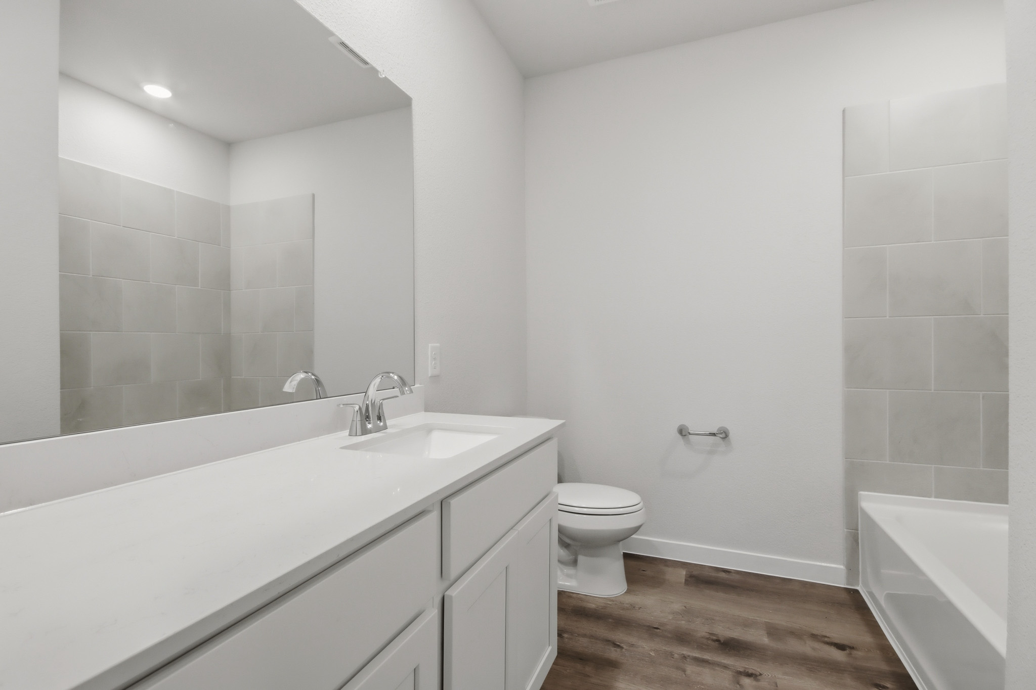 A bathroom with a tub sink and toilet.