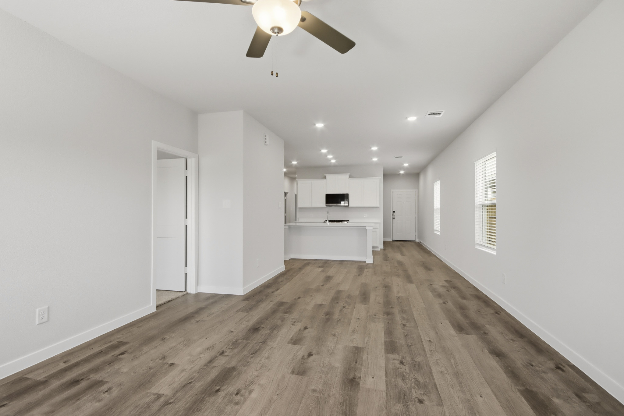 A room with white walls and a wood floor.