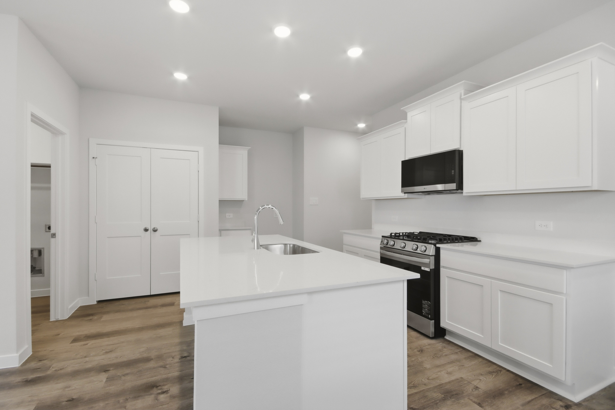 A kitchen with white cabinets.