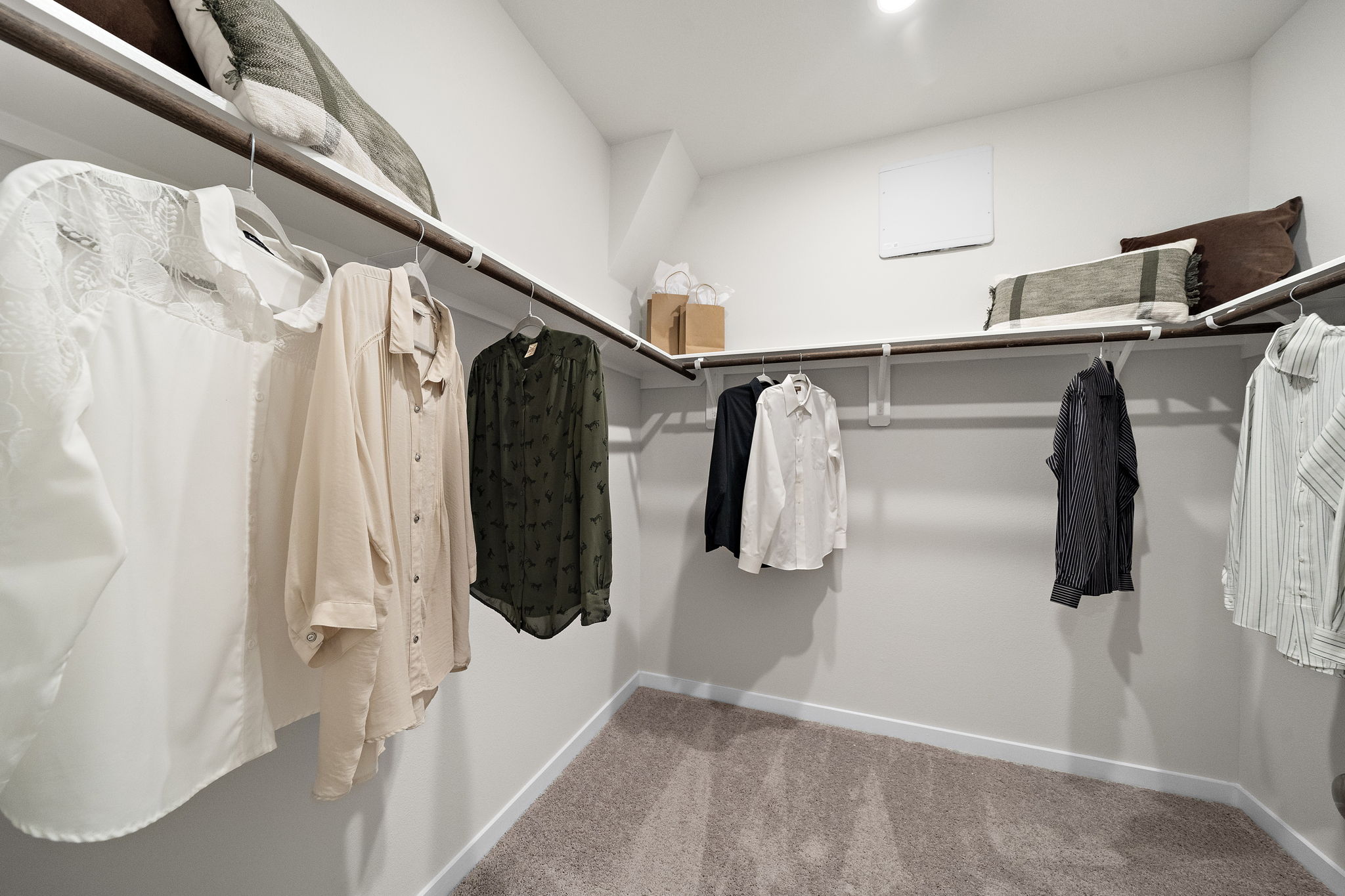 A room with a row of clothes on a rack.