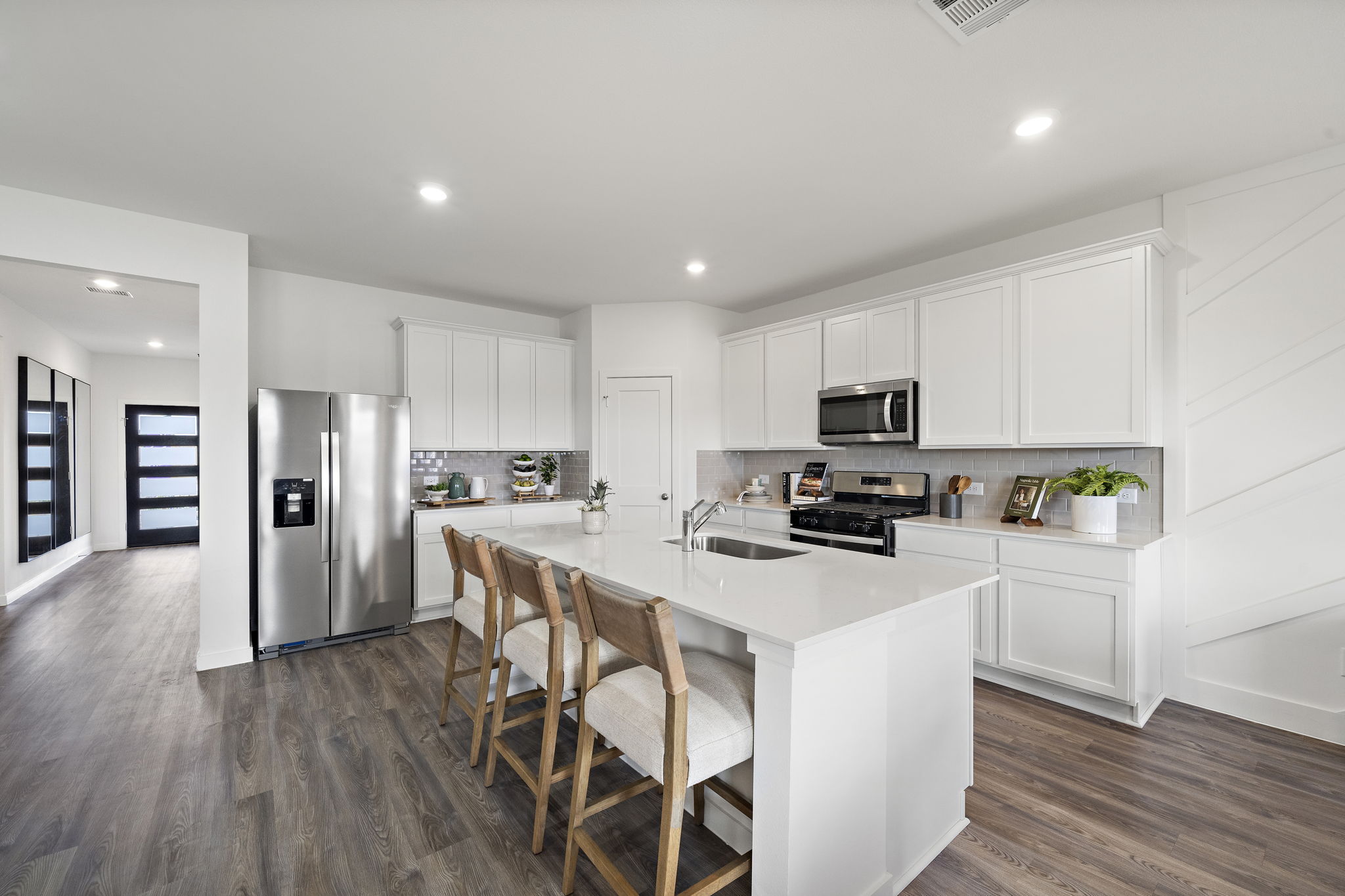 A kitchen with white cabinets.