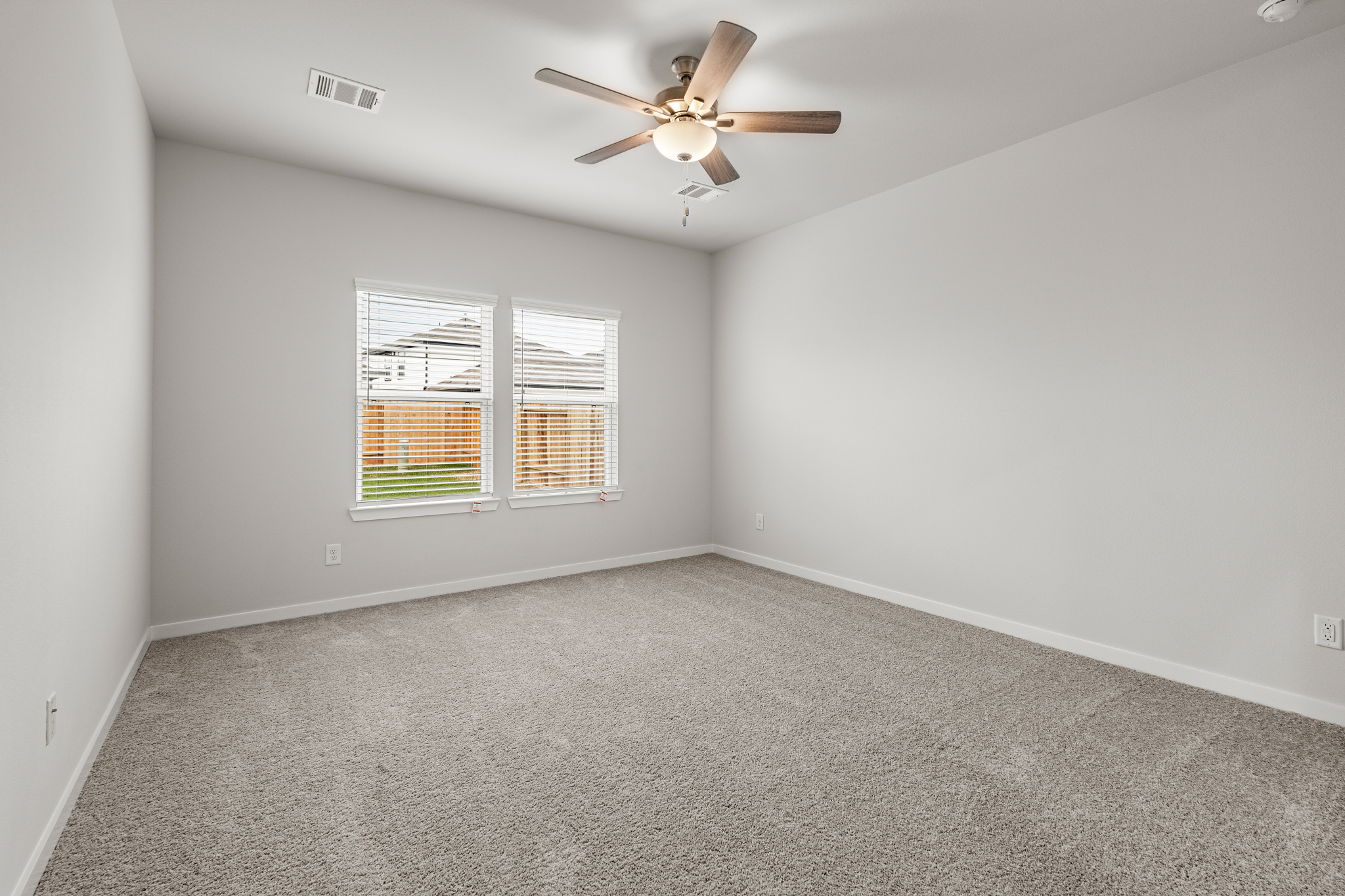 A room with a ceiling fan and a ceiling fan.
