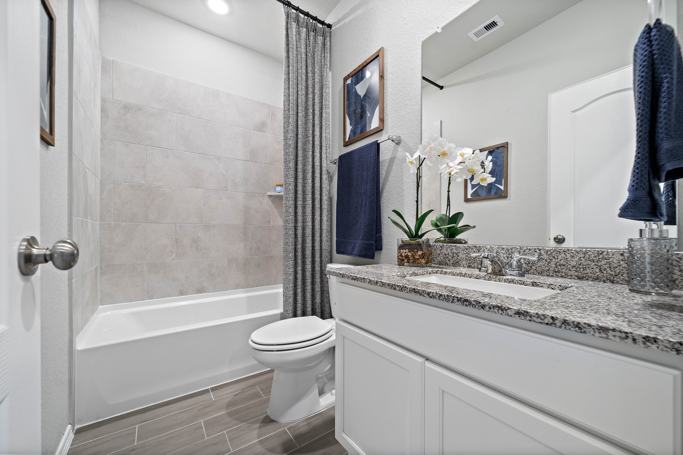 A bathroom with a marble countertop.