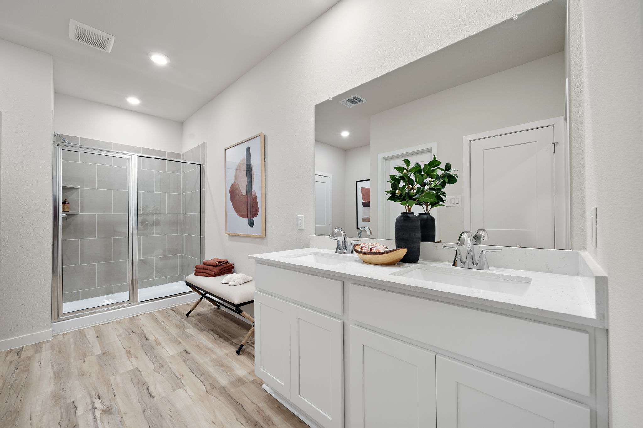 A bathroom with a sink and a shower.