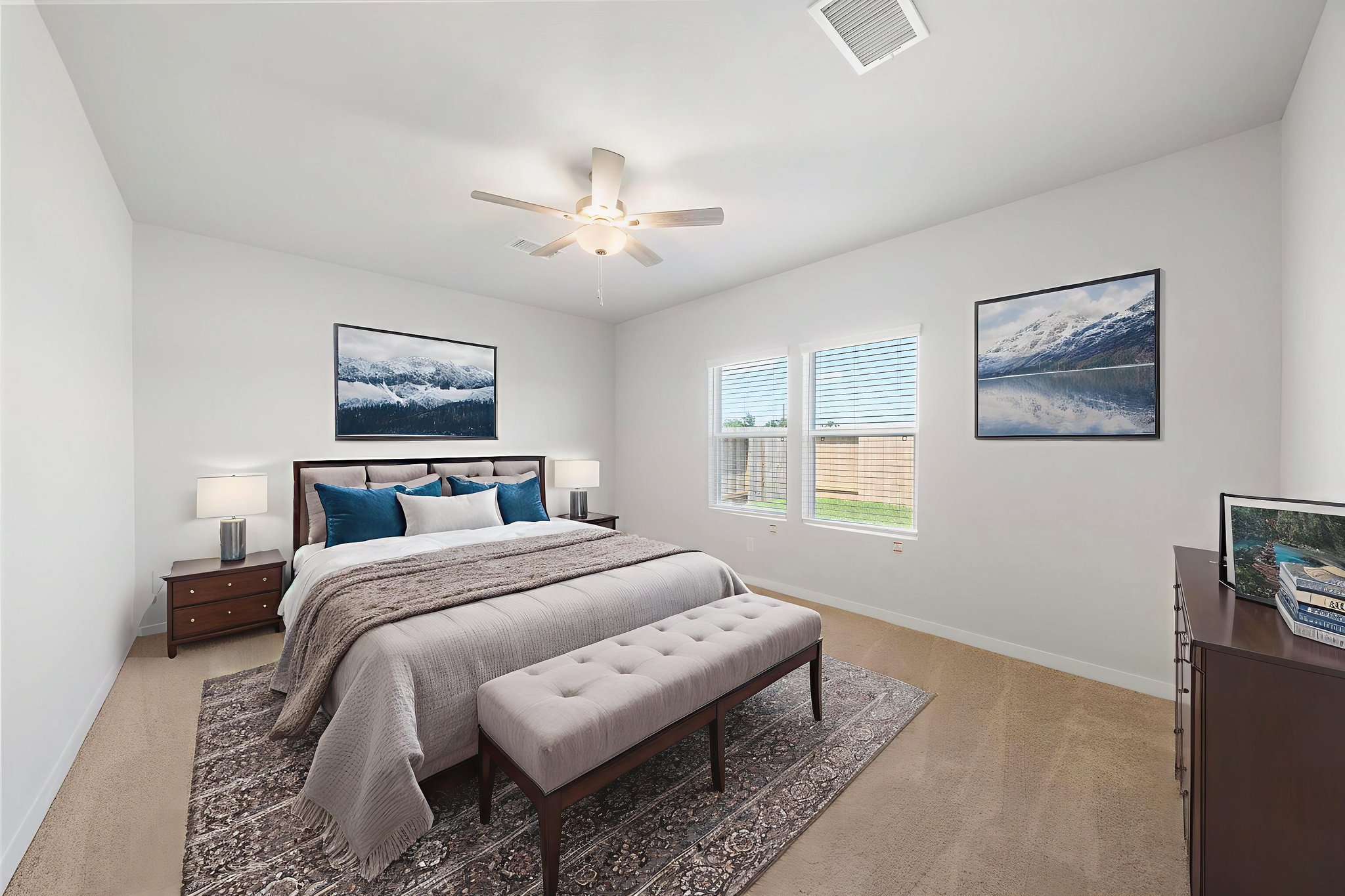 A bedroom with a bed and a bench.