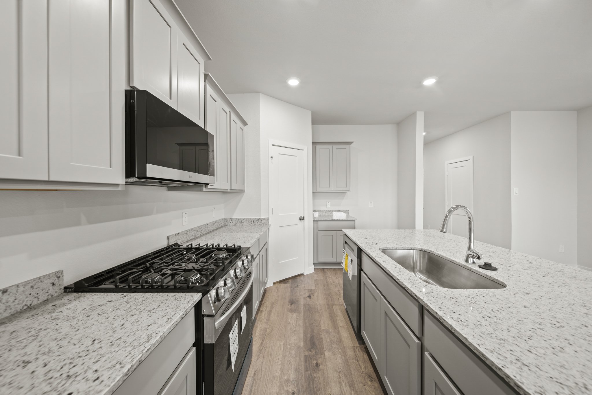 A kitchen with white cabinets.
