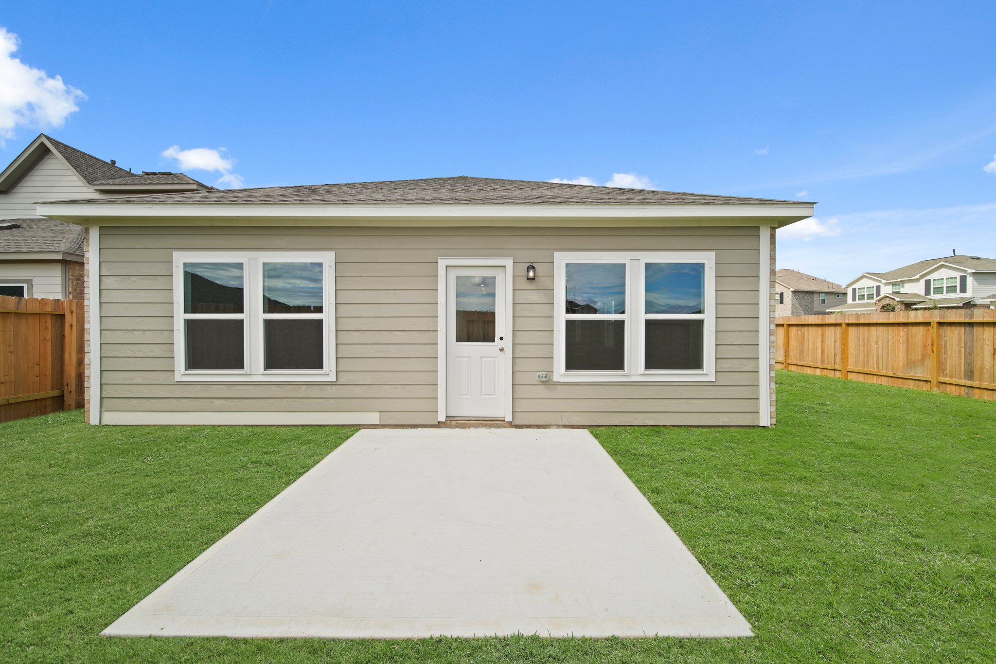 A house with a pool in the front yard.