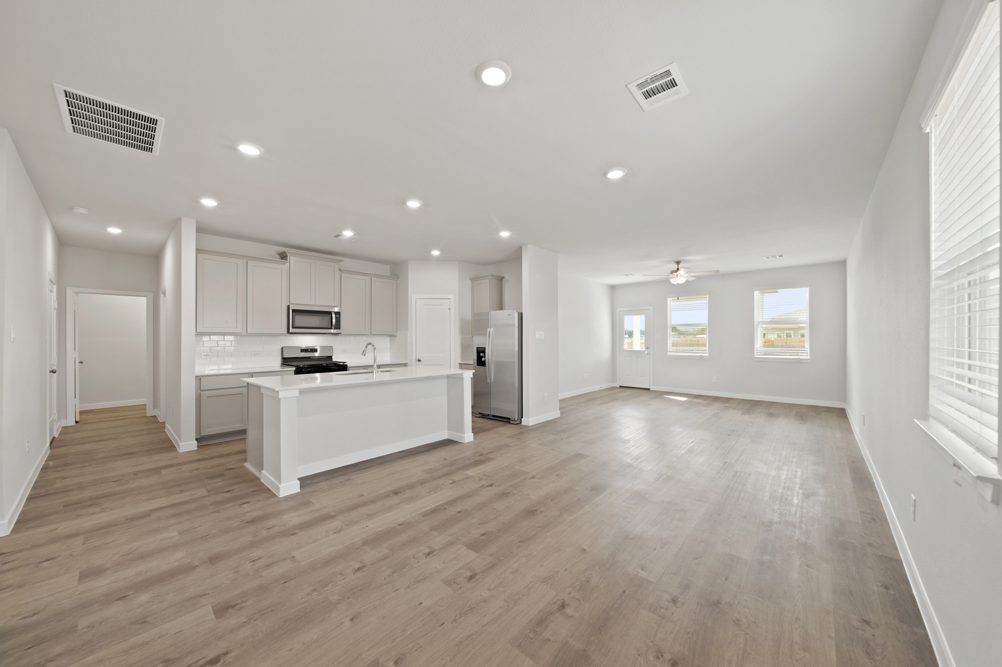 A large kitchen with white cabinets.