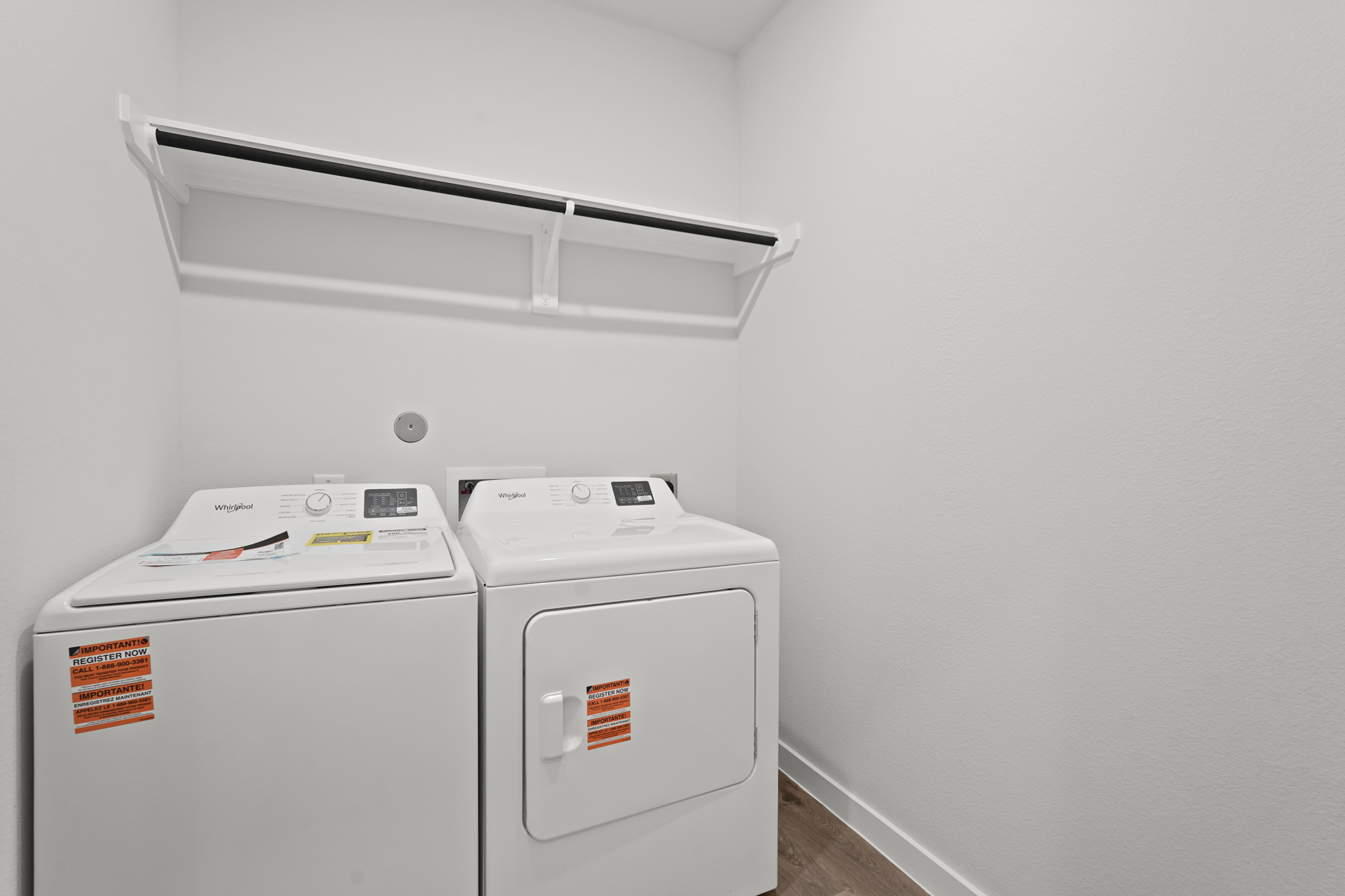 A white machine with a white shelf.