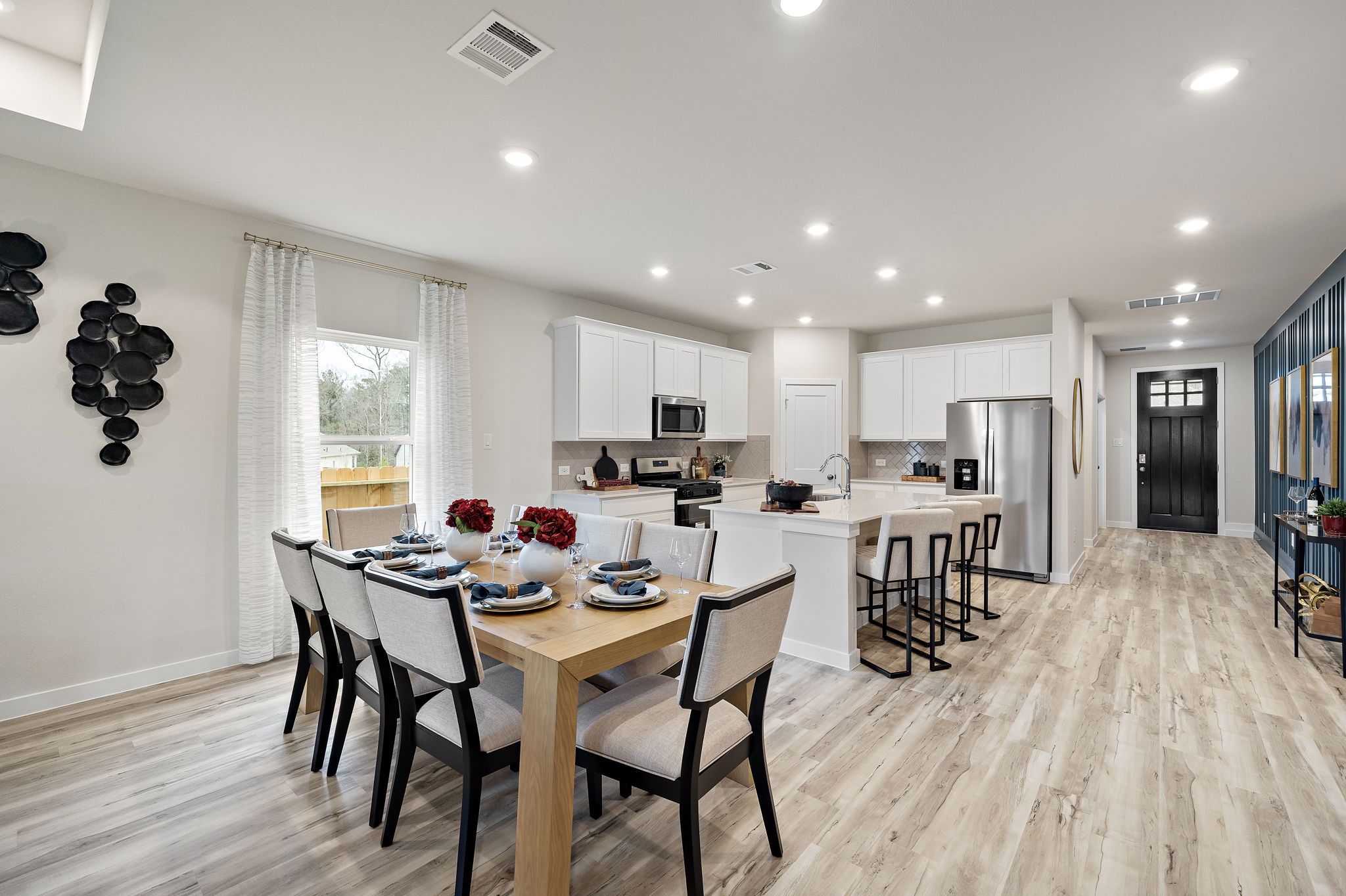 A large kitchen with a dining table.