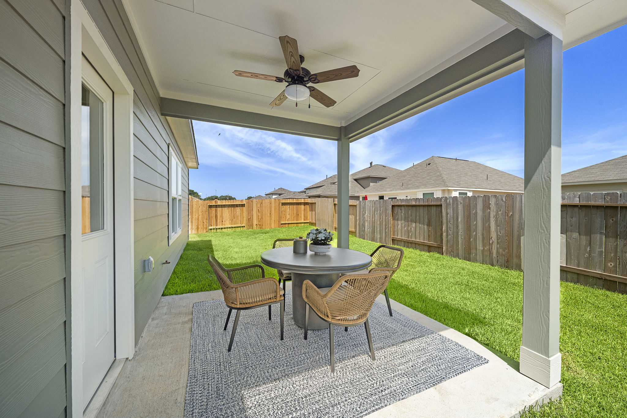 A table and chairs on a patio.
