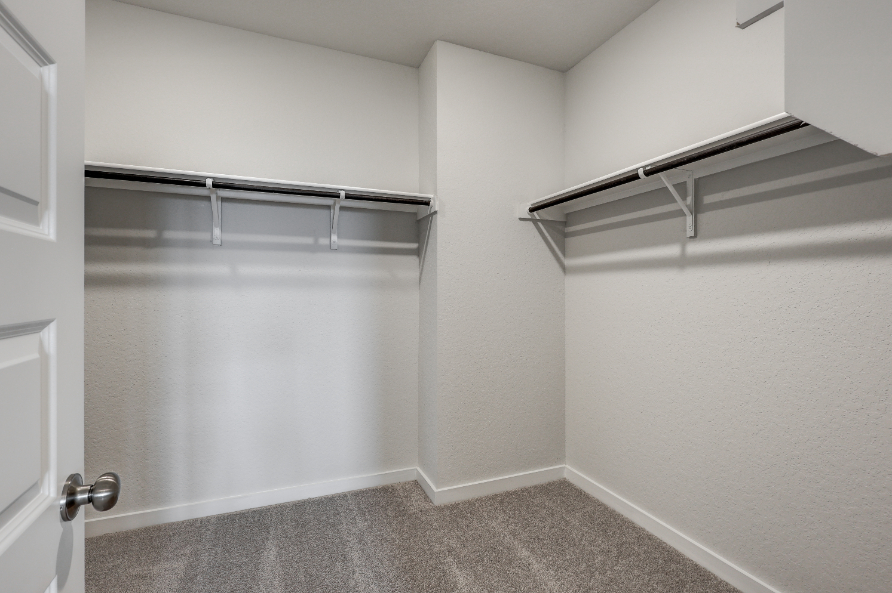 A white room with a metal railing.