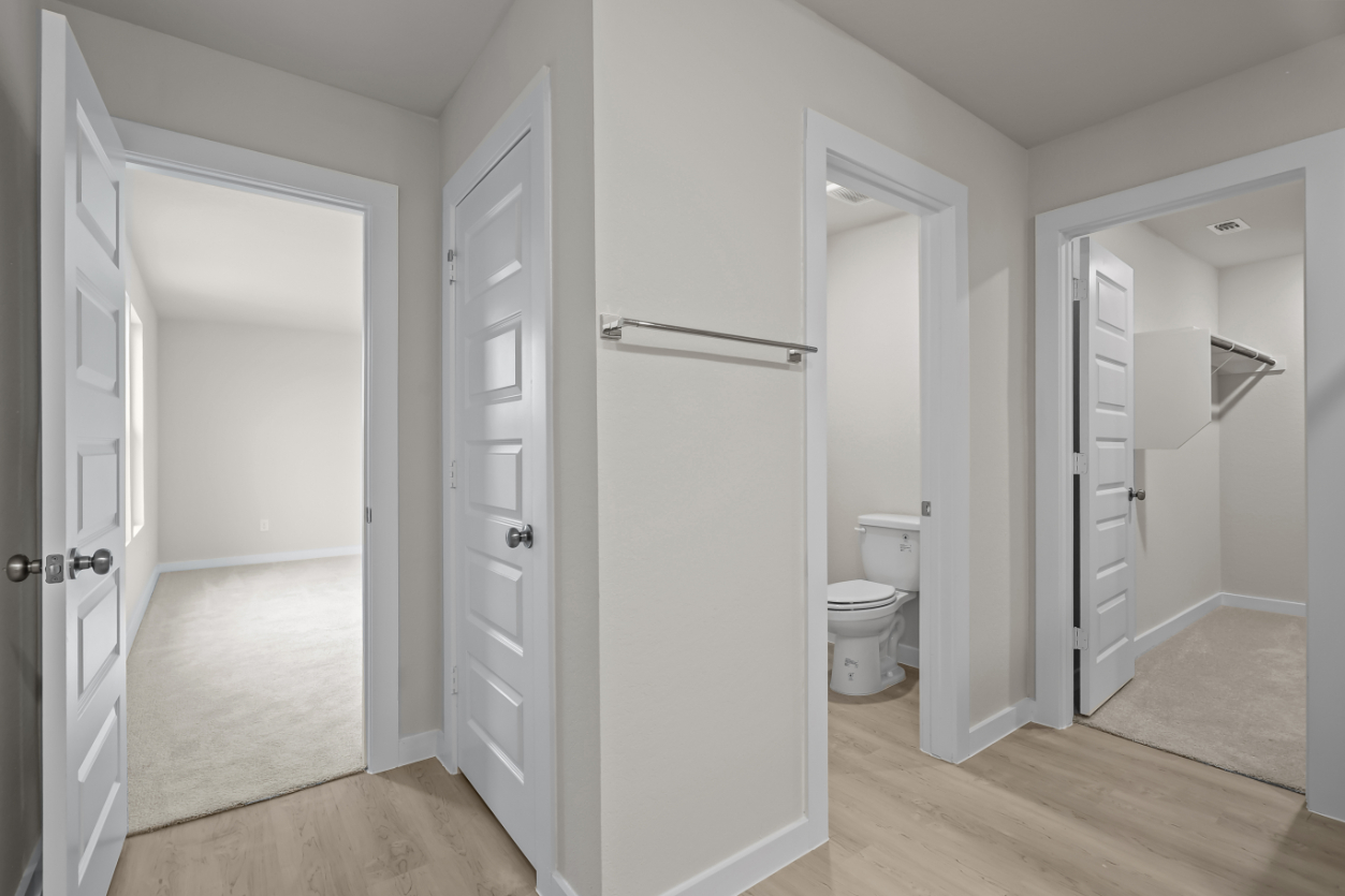 A bathroom with white doors.