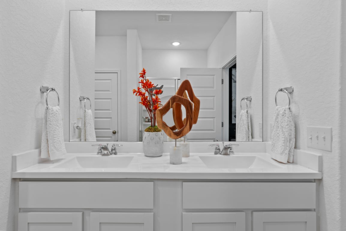 A bathroom with a large mirror.