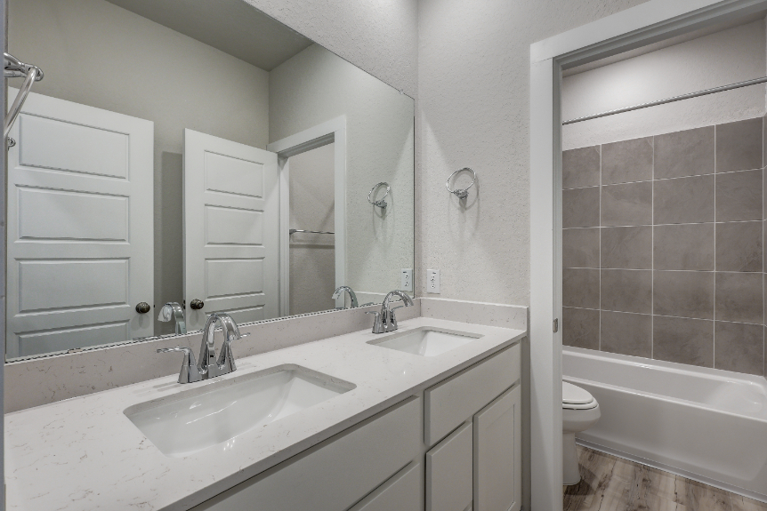 A bathroom with a tub sink and toilet.