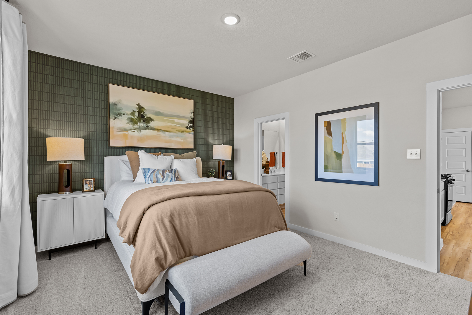 A bedroom with a bed and lamps.