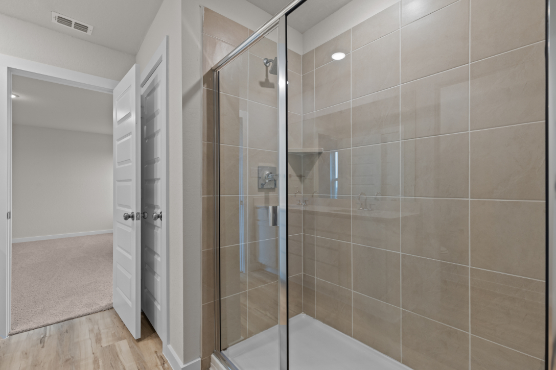 A shower with a glass door.