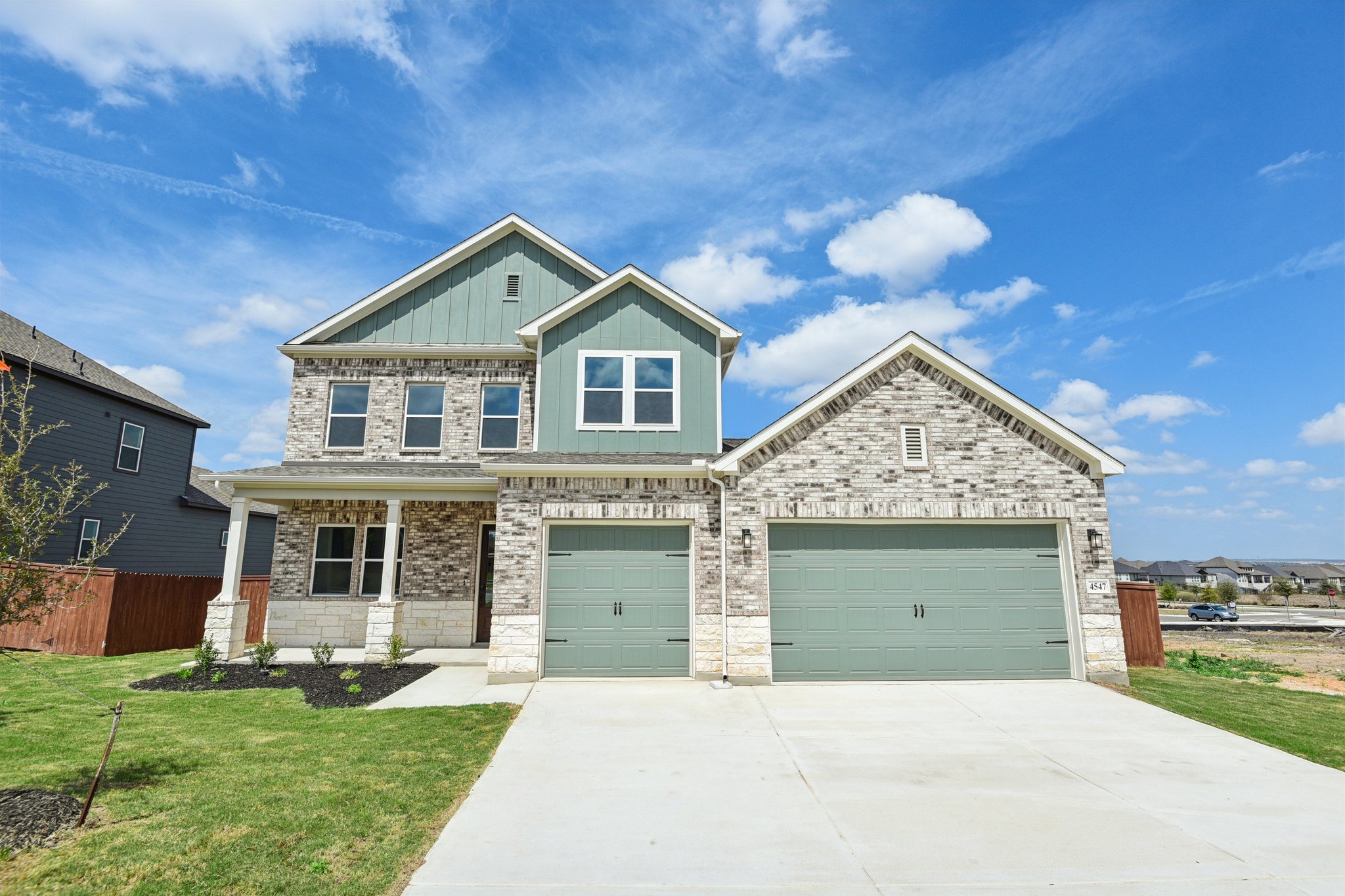 A house with garages and grass.