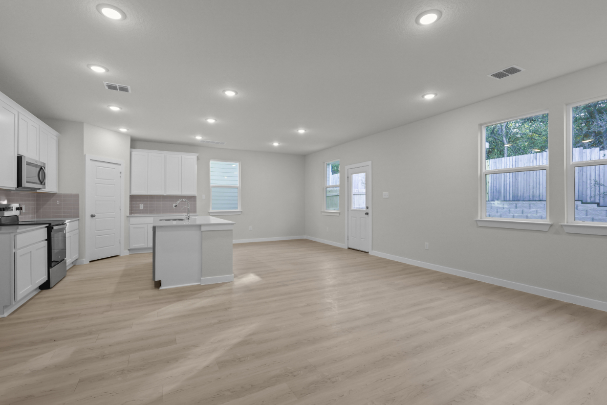 A large kitchen with white cabinets.
