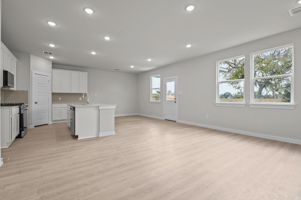 A large kitchen with white cabinets.