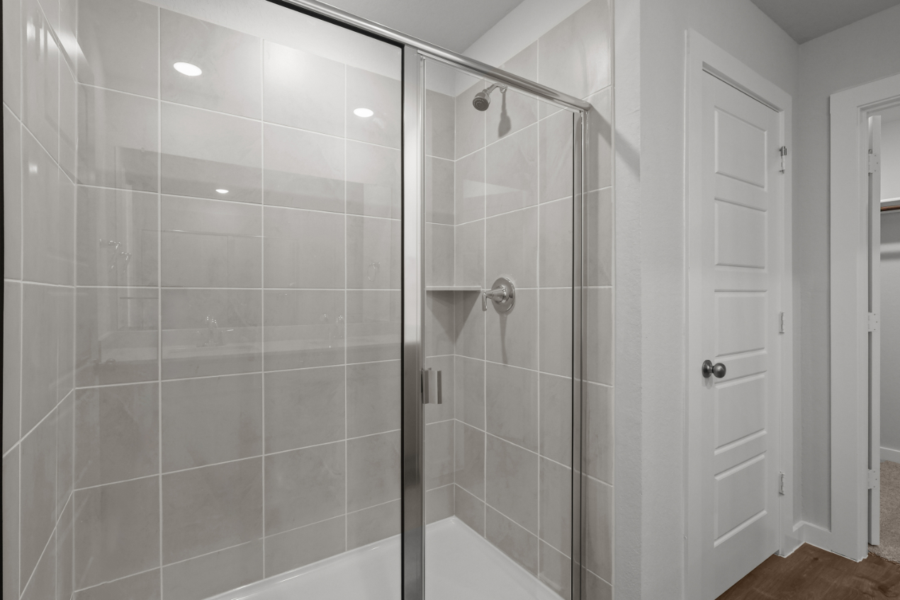 A shower with a glass door.
