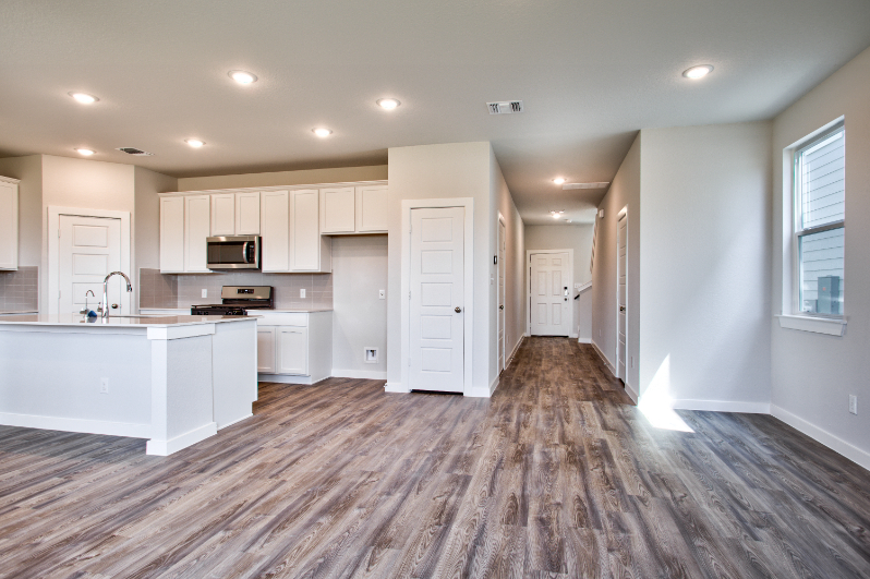 A kitchen with white cabinets.