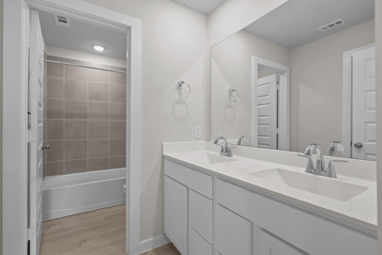 A bathroom with a tub sink and a shower.