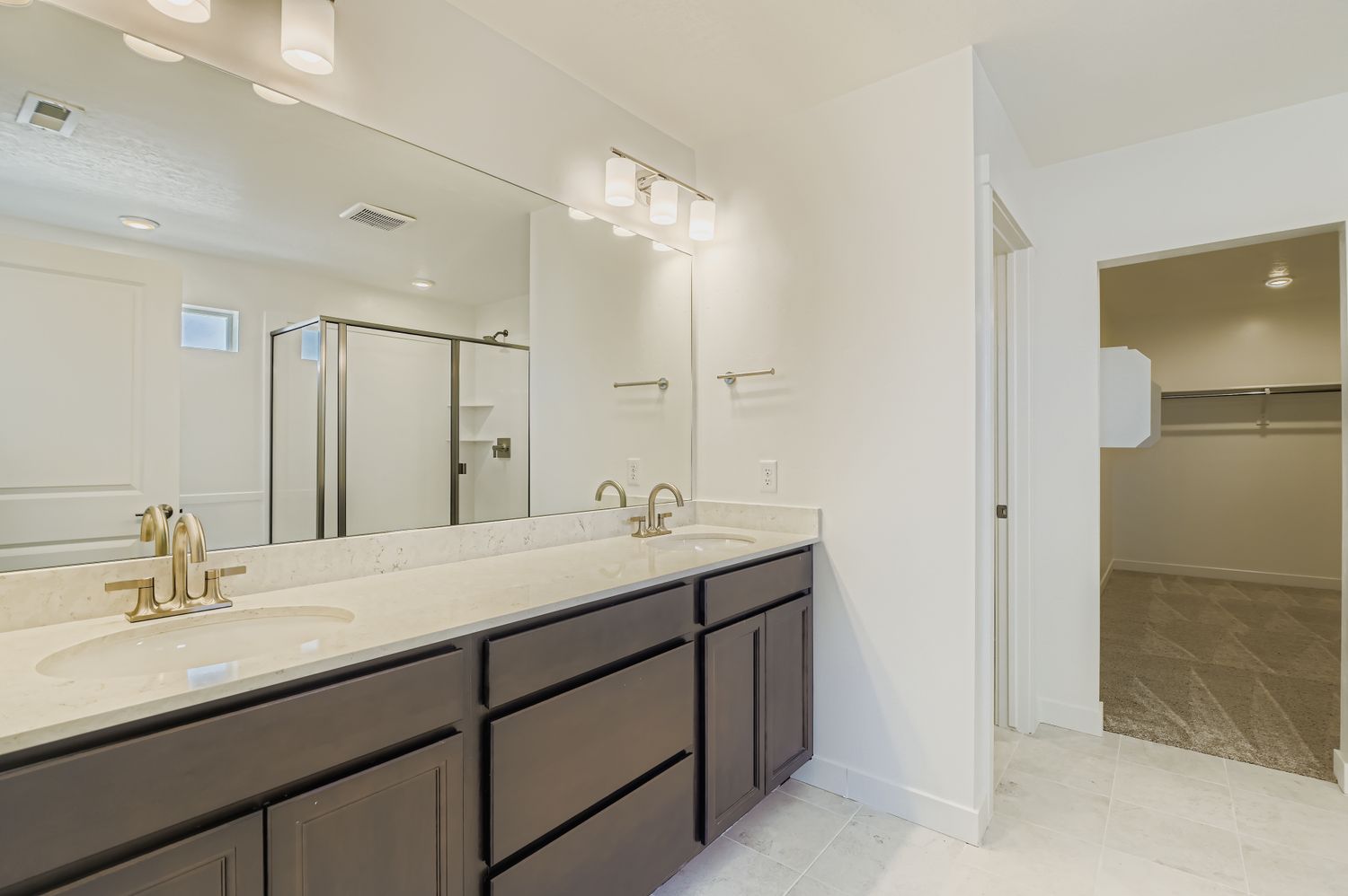 A bathroom with a large mirror.