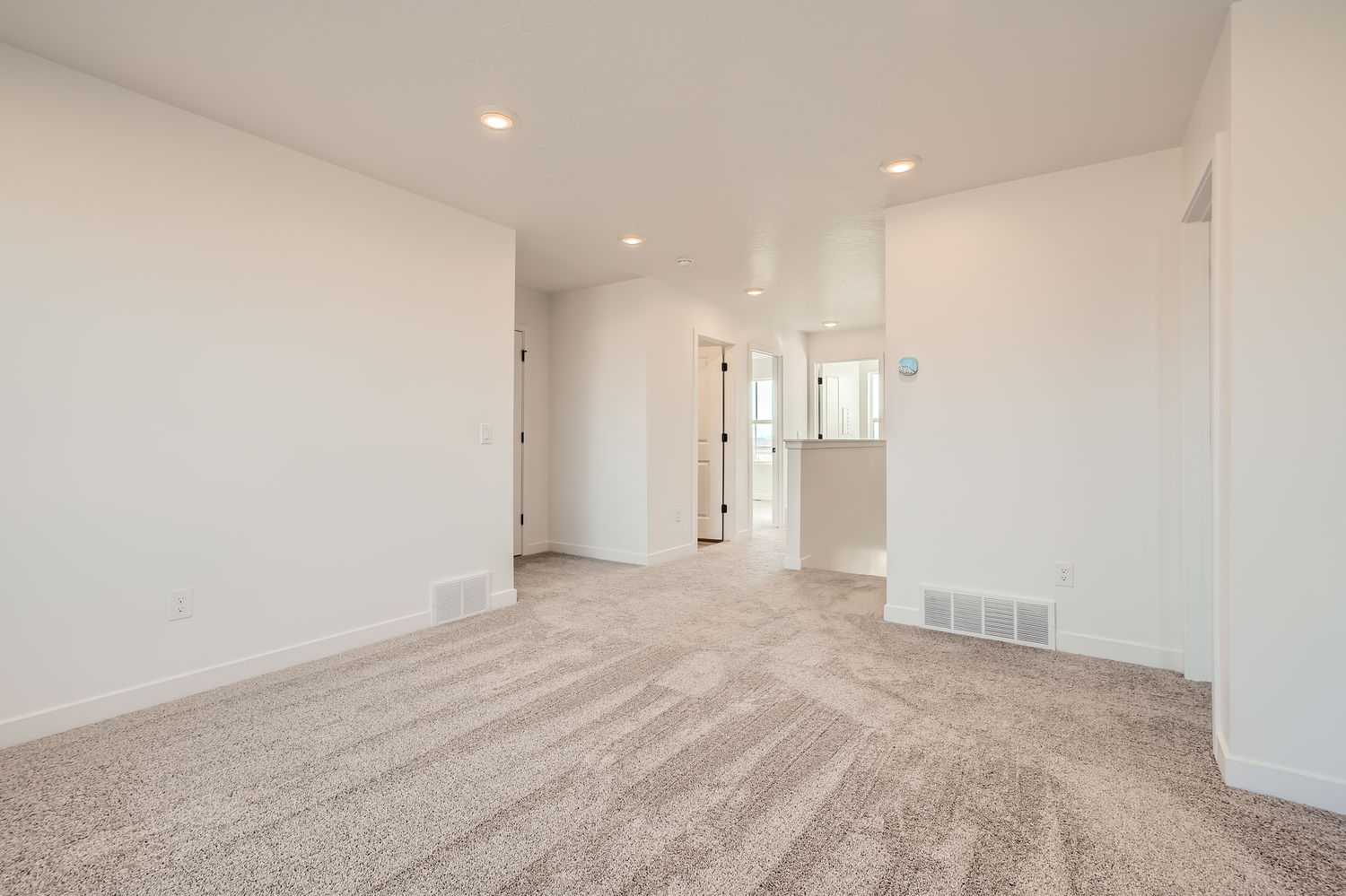 A long hallway with white walls.