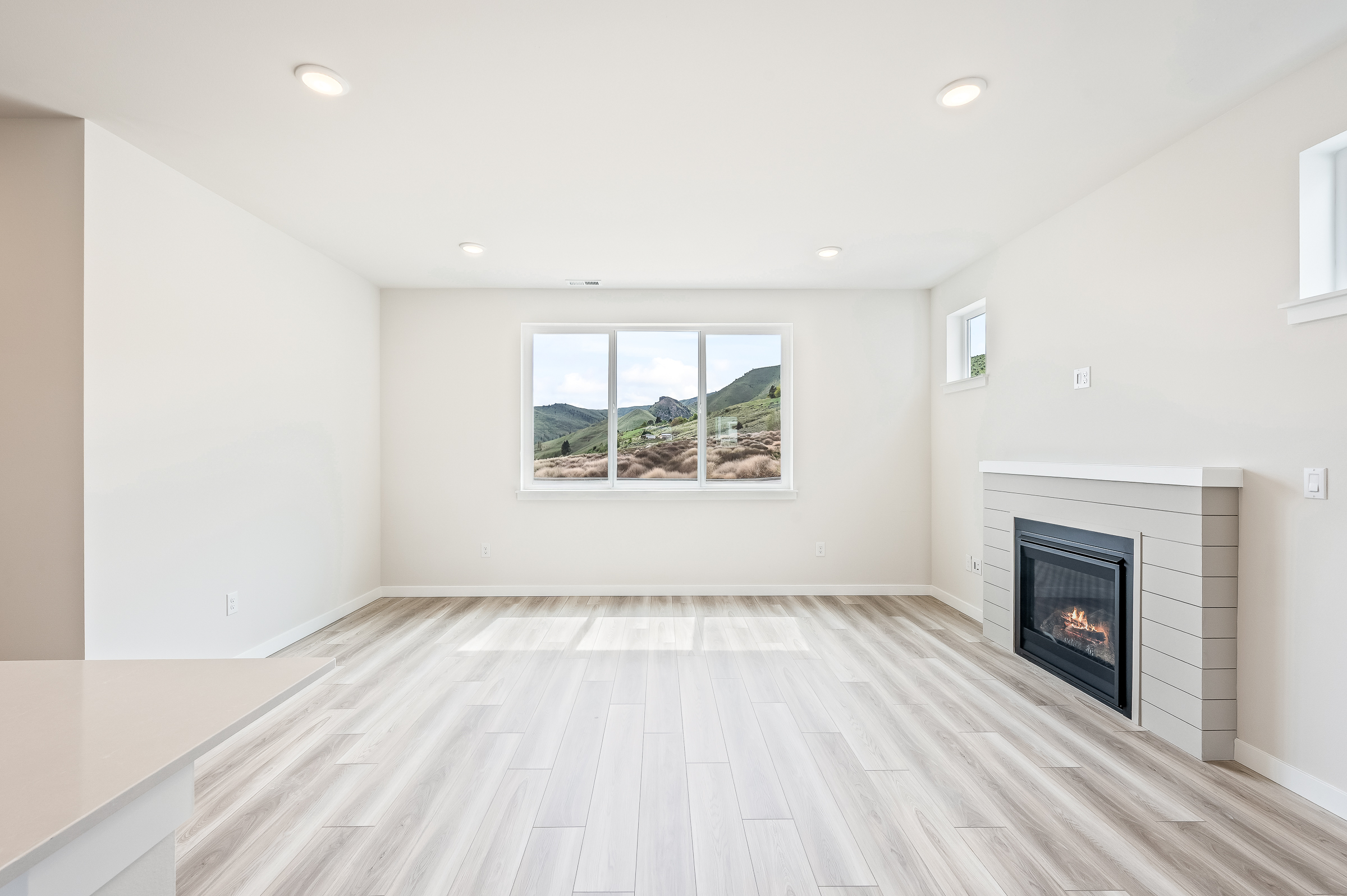 A room with a fireplace and a wood floor.