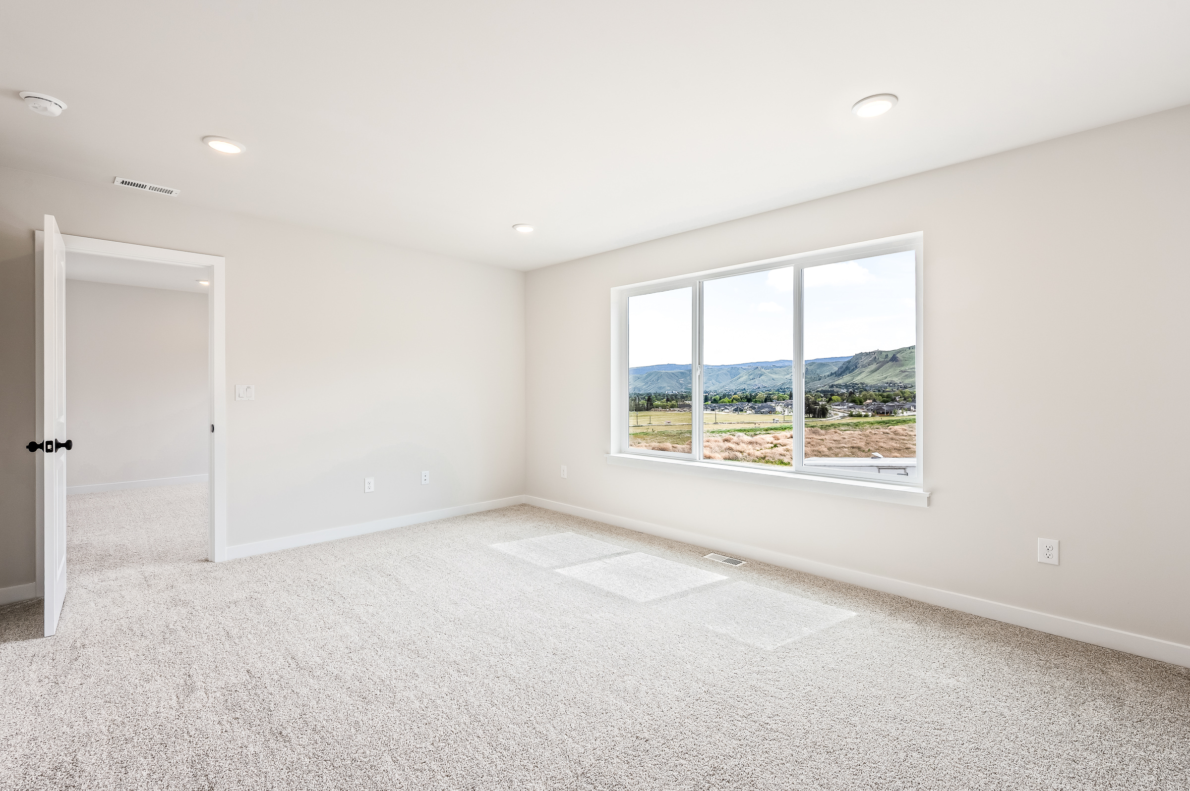 A room with a window and a door.