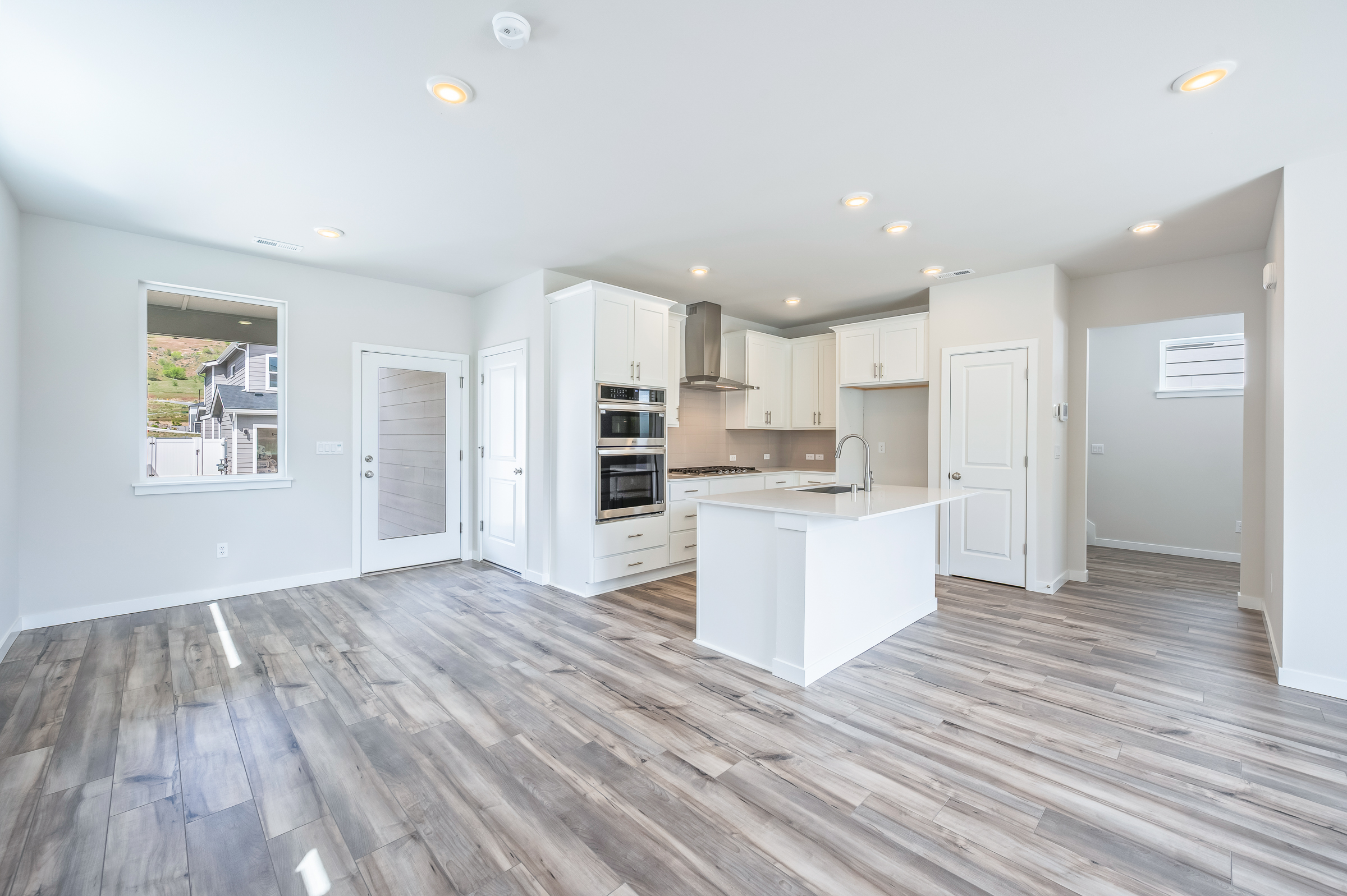 A kitchen with white cabinets.