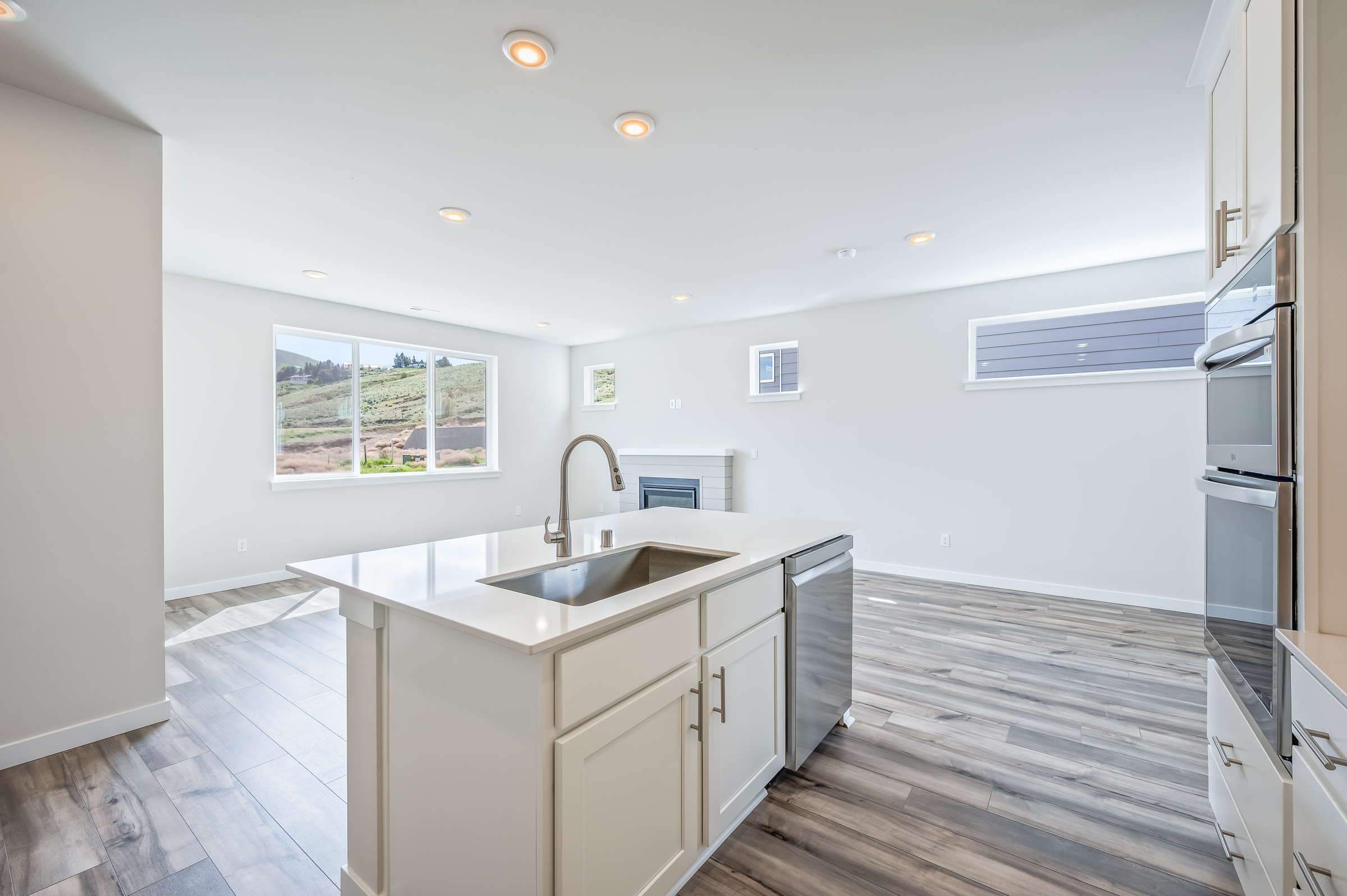A kitchen with white cabinets.