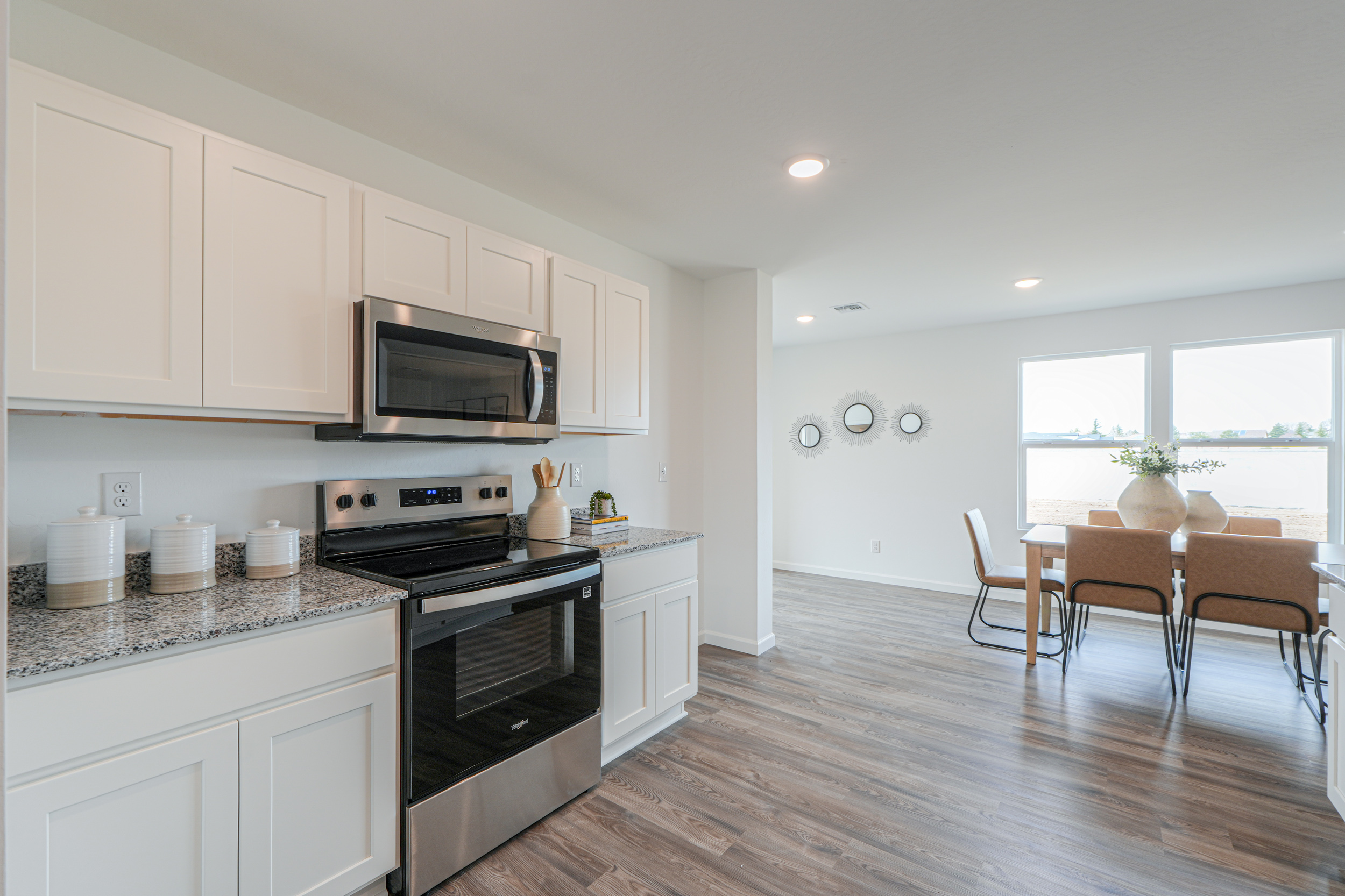 A kitchen with white cabinets.