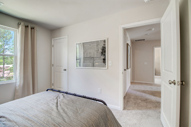 A bedroom with a large mirror.