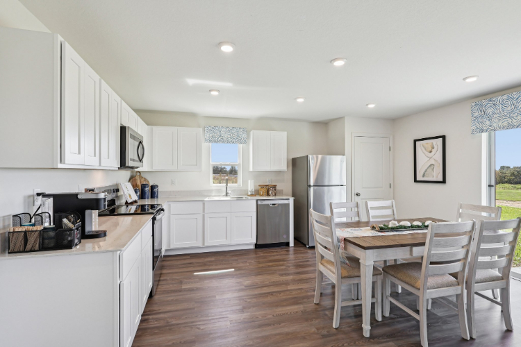 A kitchen with white cabinets.