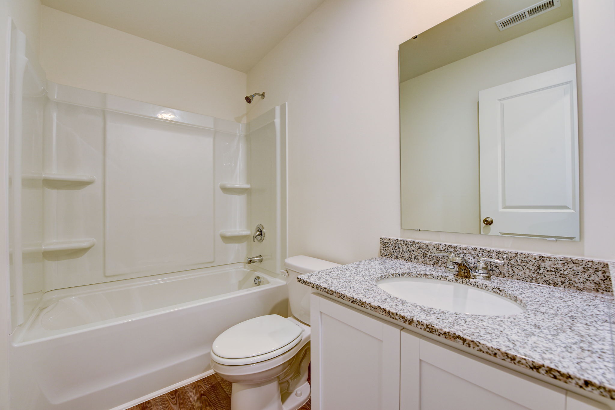 A bathroom with a marble countertop.