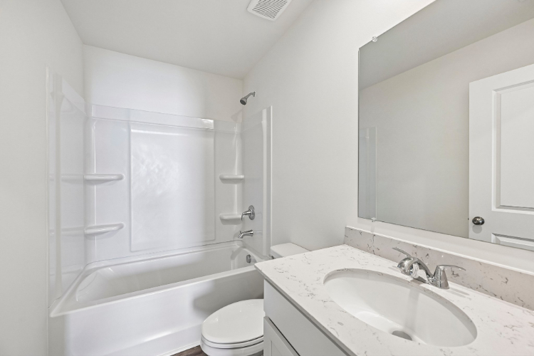 A bathroom with a sink and a toilet.
